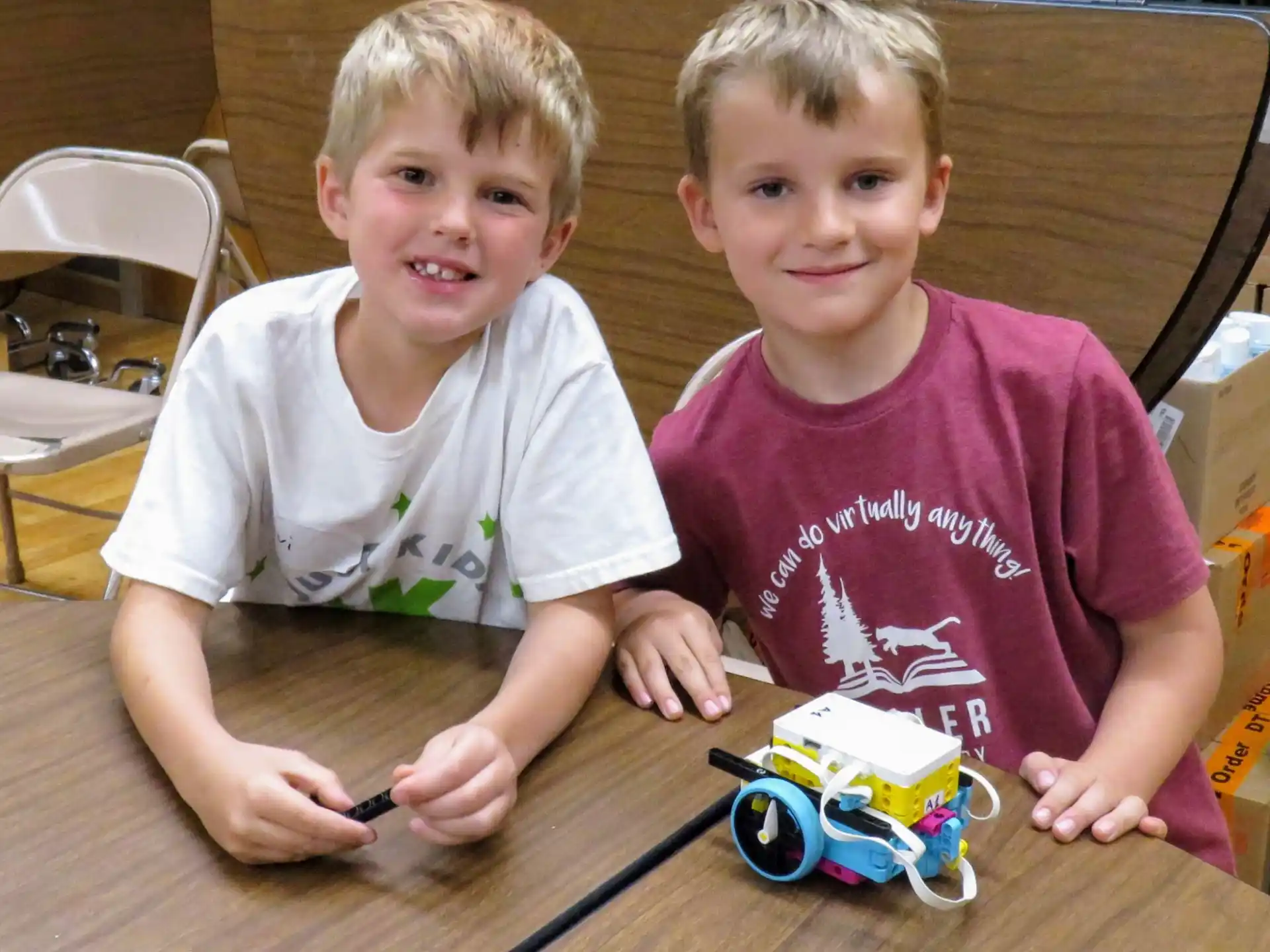 two boys sitting at a table