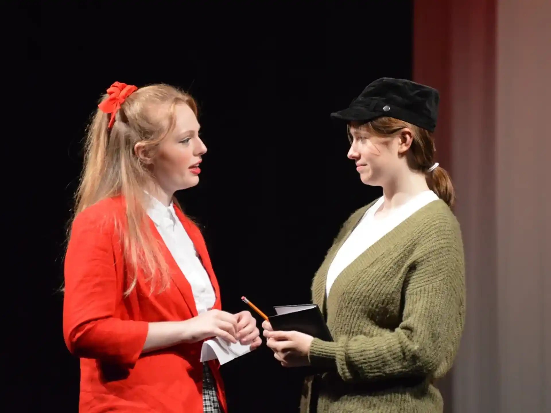 a woman and a woman looking at a book