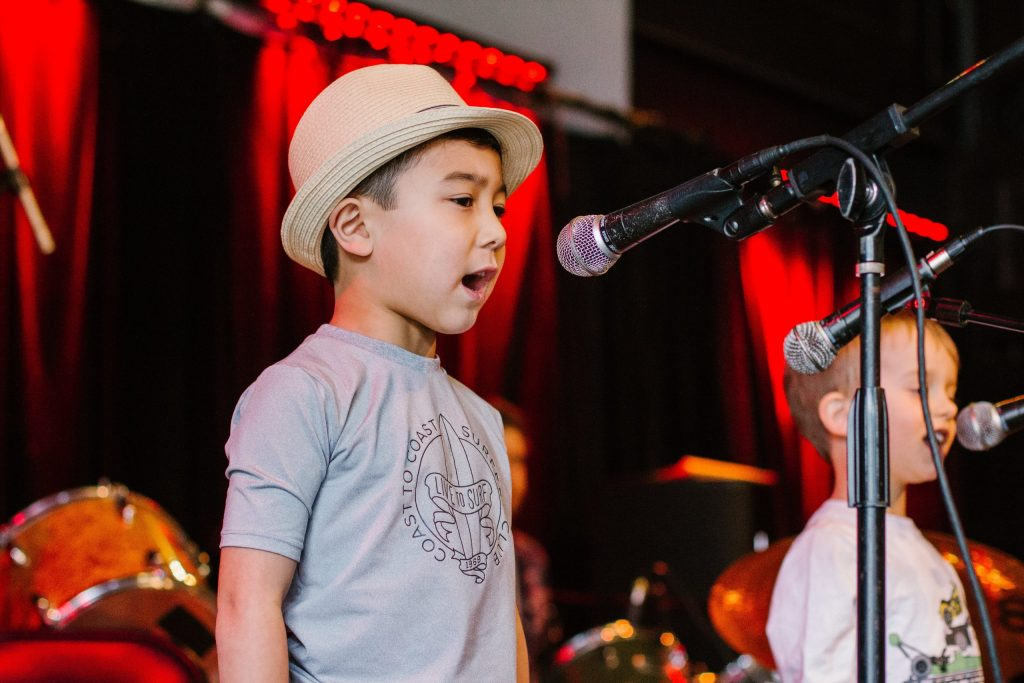 a boy singing into a microphone