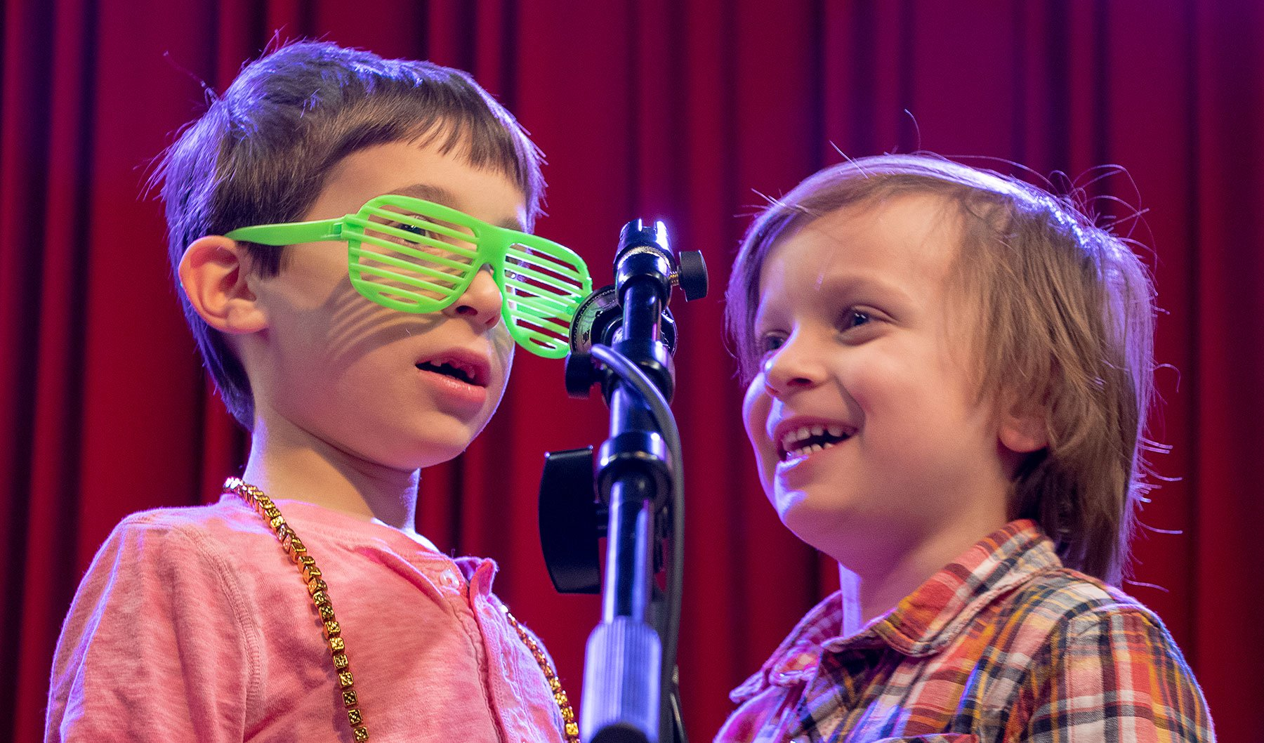 a couple of children with green glasses