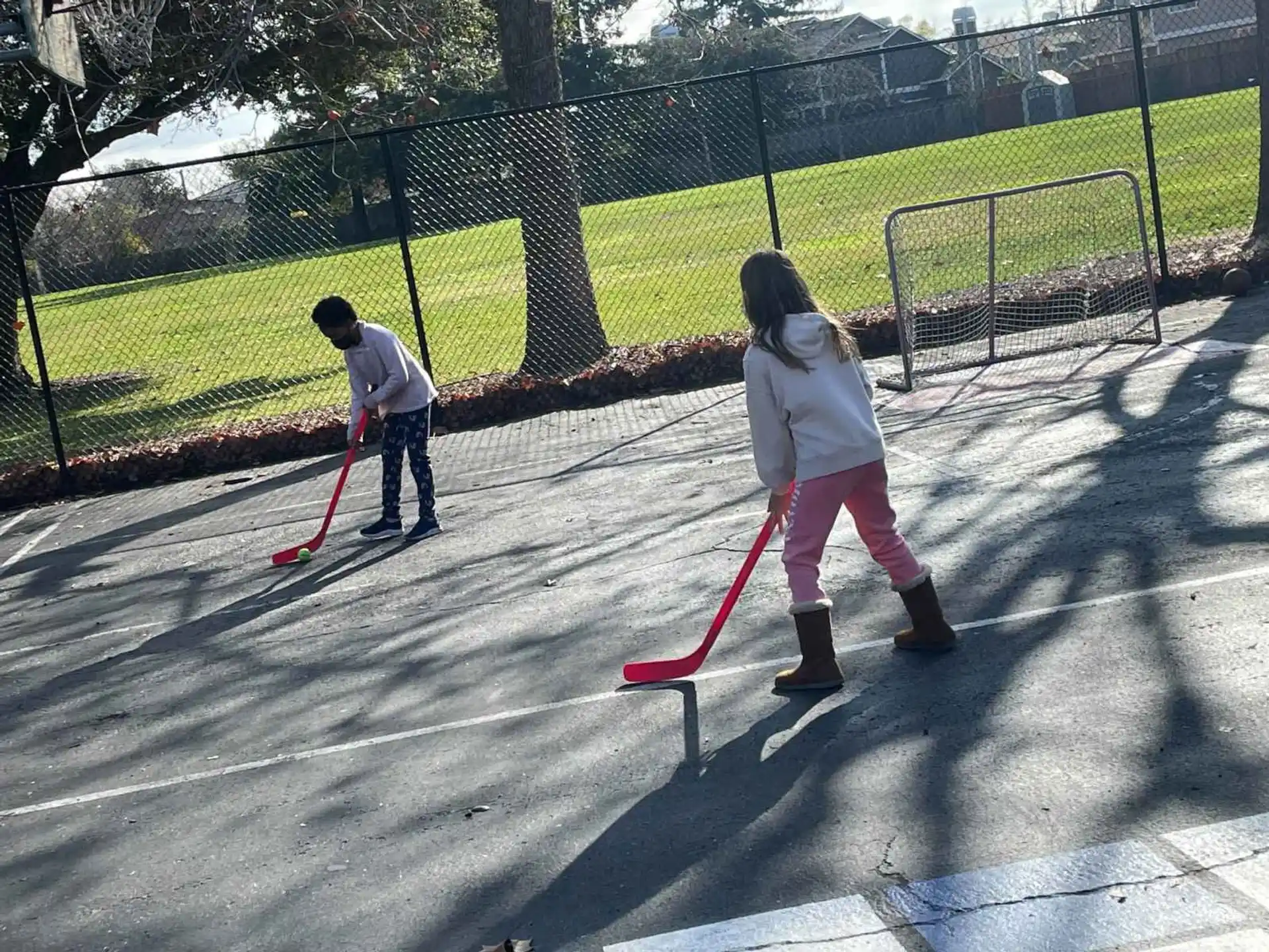 a couple of people playing with a red and white toy