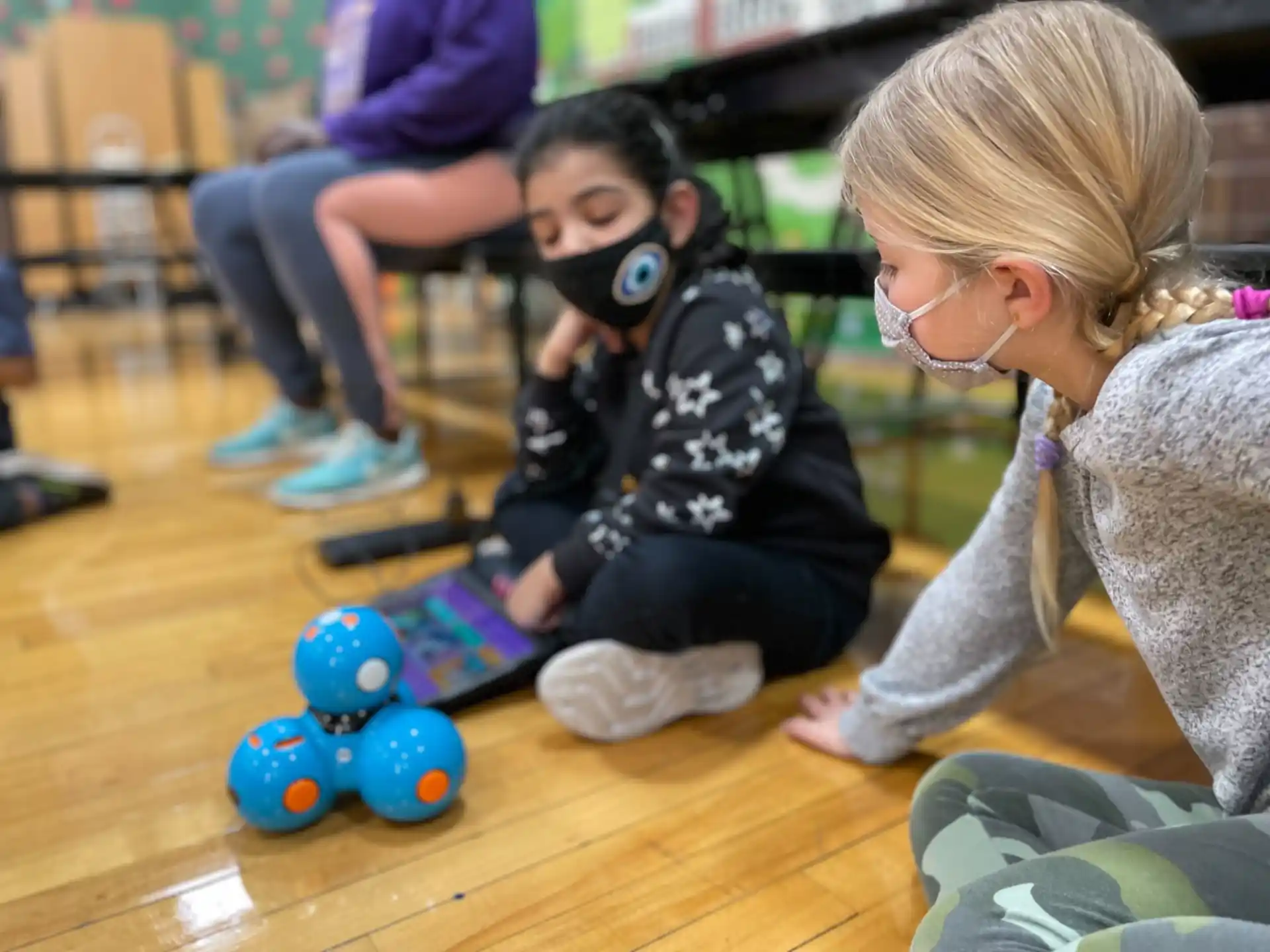 a person and a child playing with toys on the floor