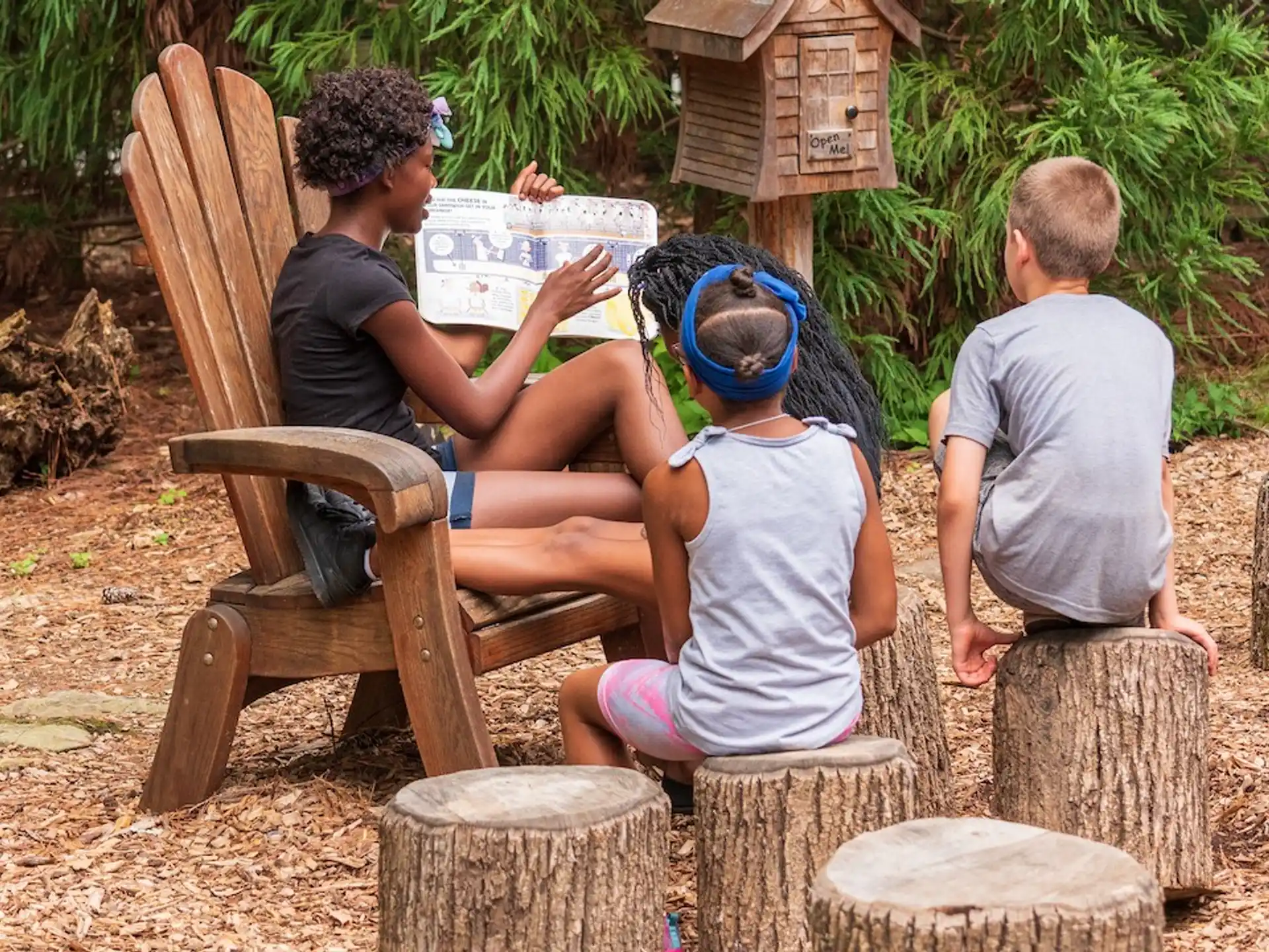 a group of people sitting on chairs outside