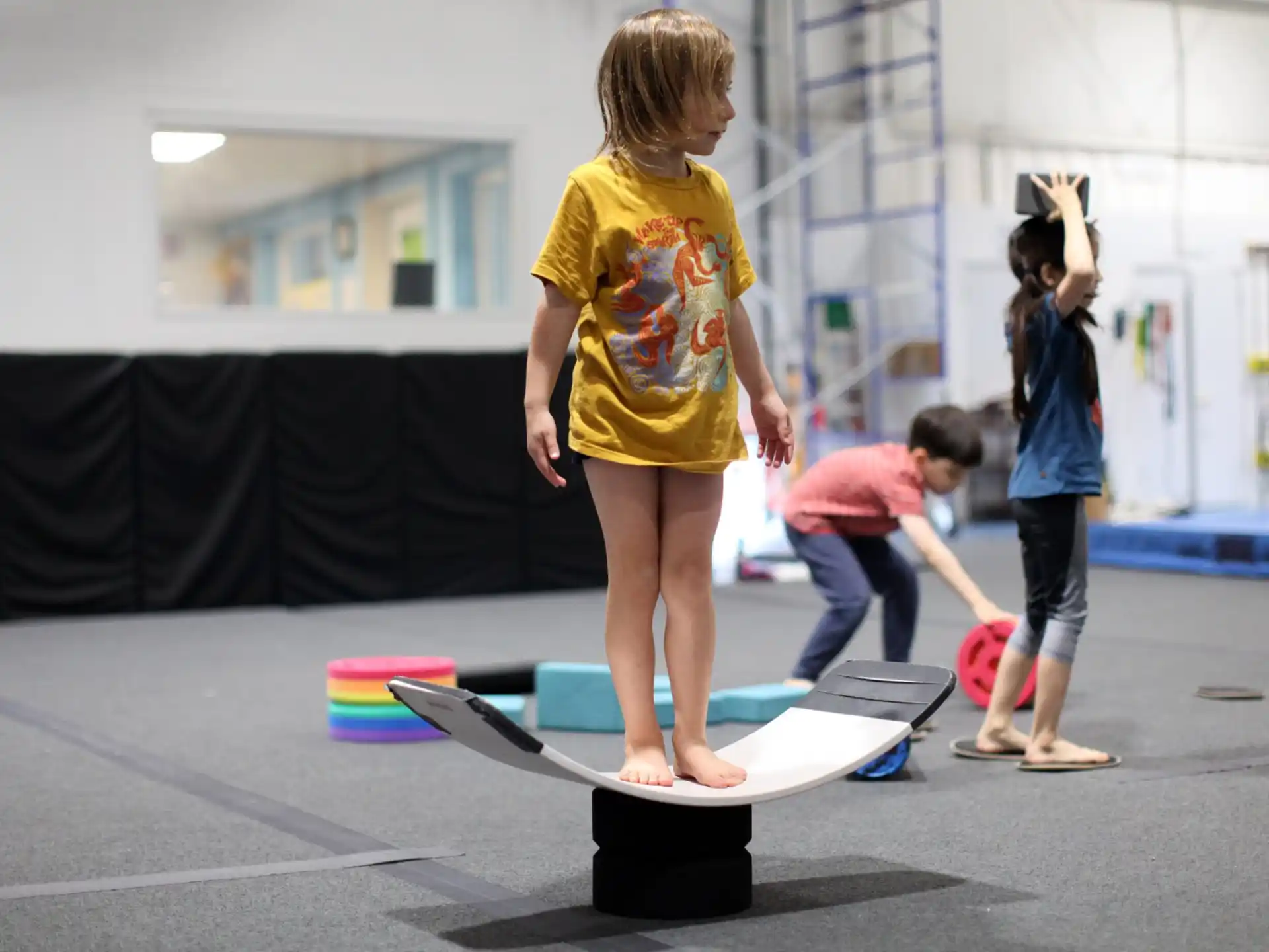 a group of kids playing on a skateboard