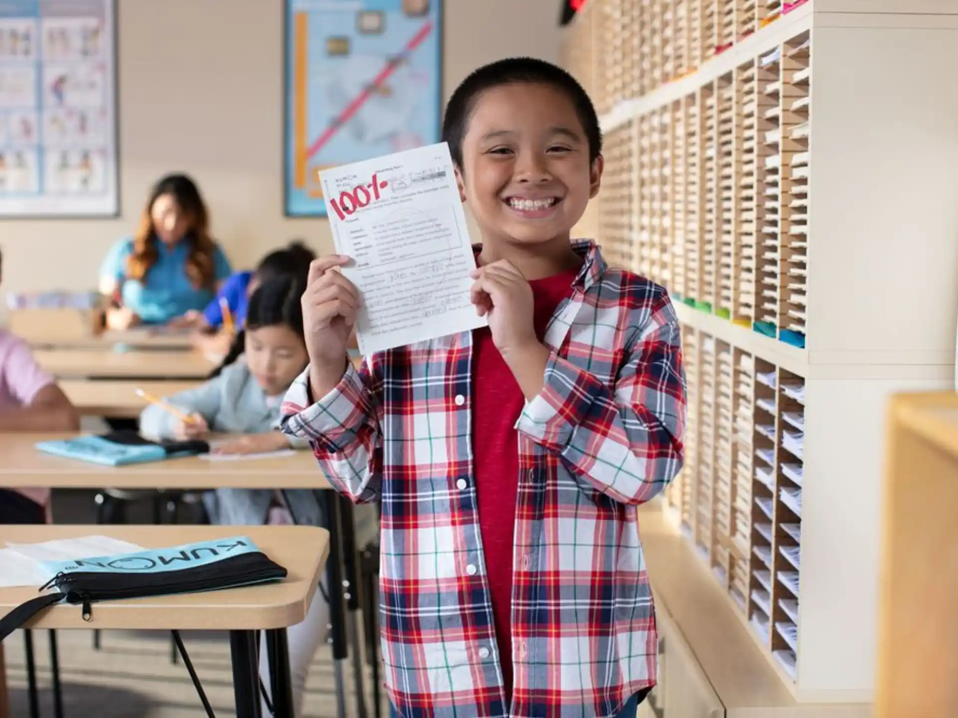 a boy holding a paper