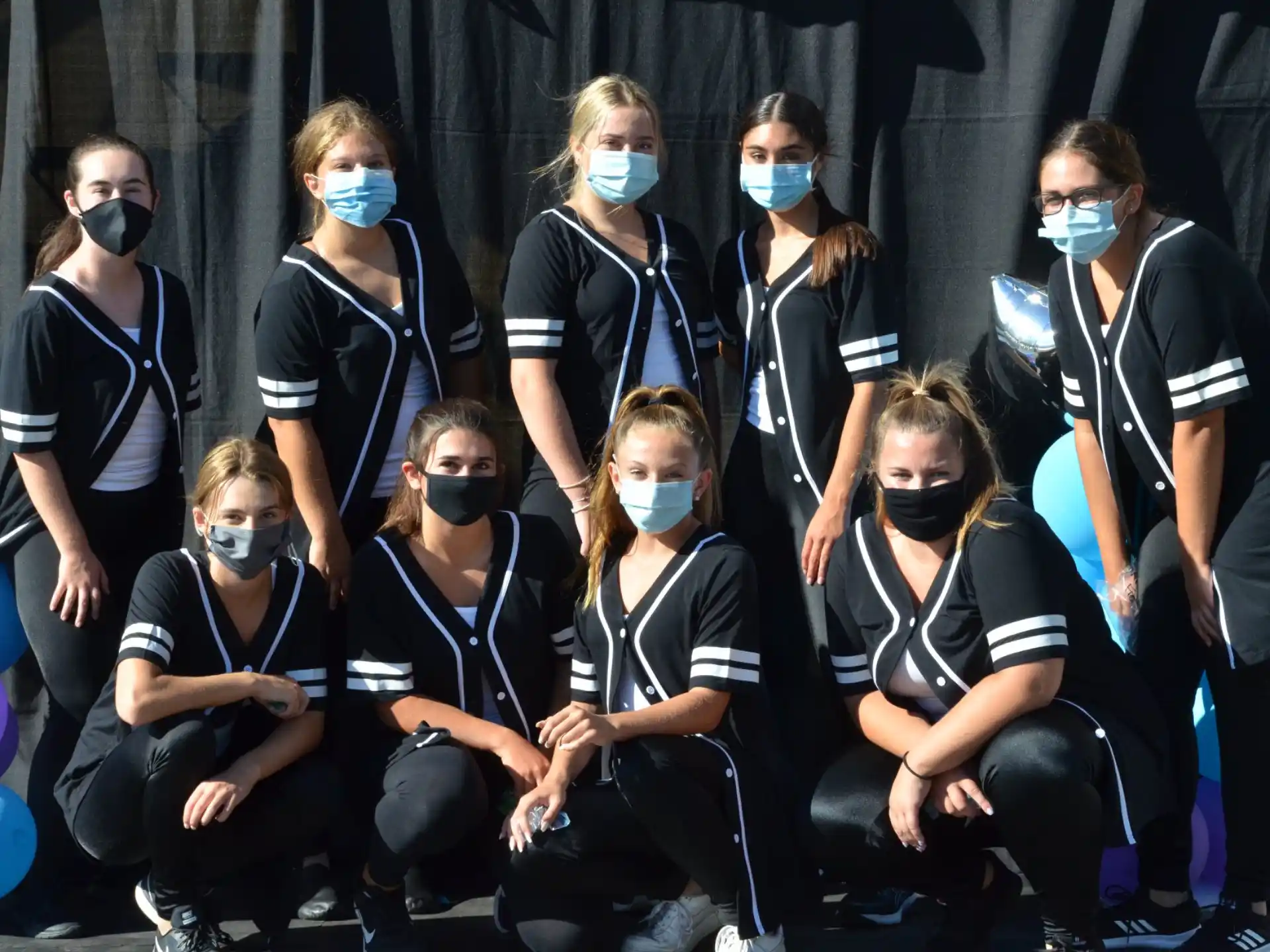 a group of people wearing masks
