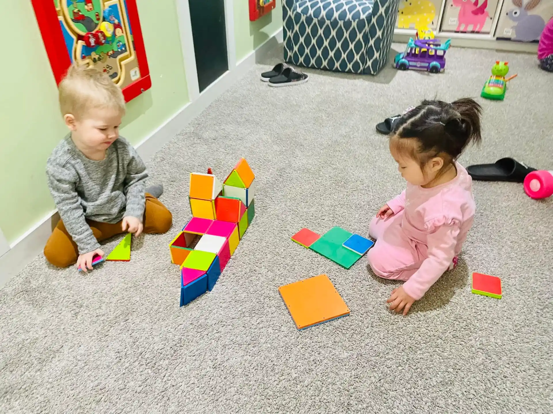 a couple of children playing with toys