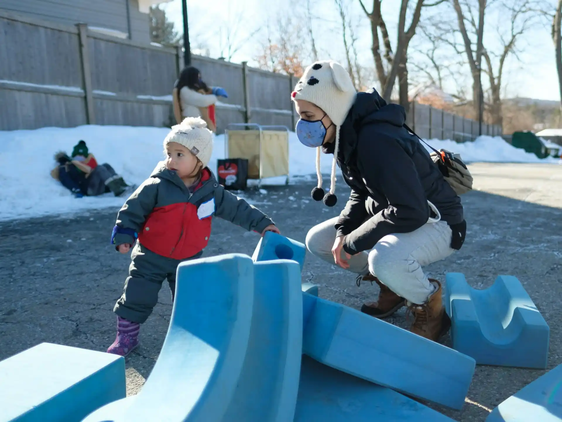 a person and a child playing in the snow