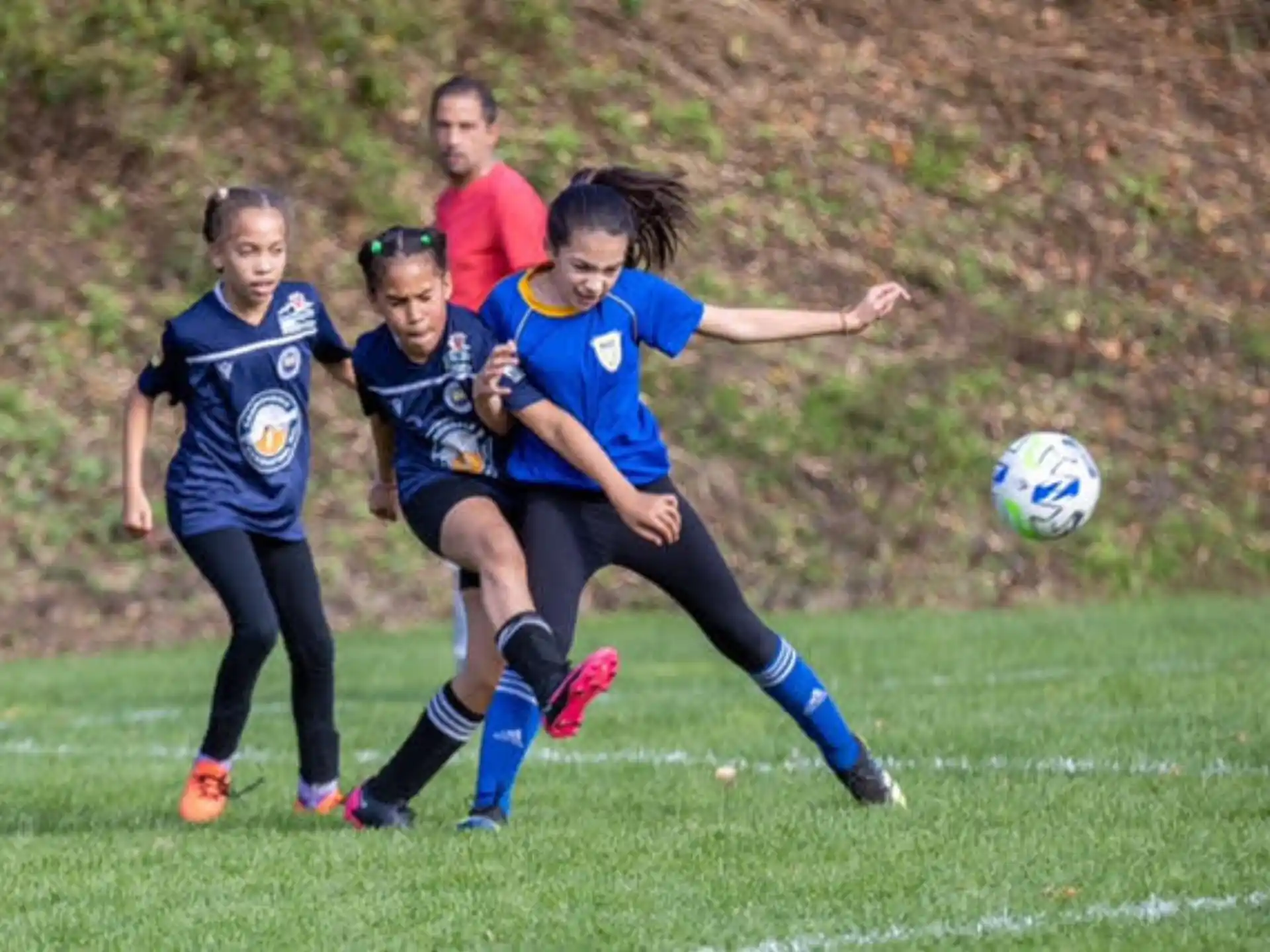girls playing football on a field