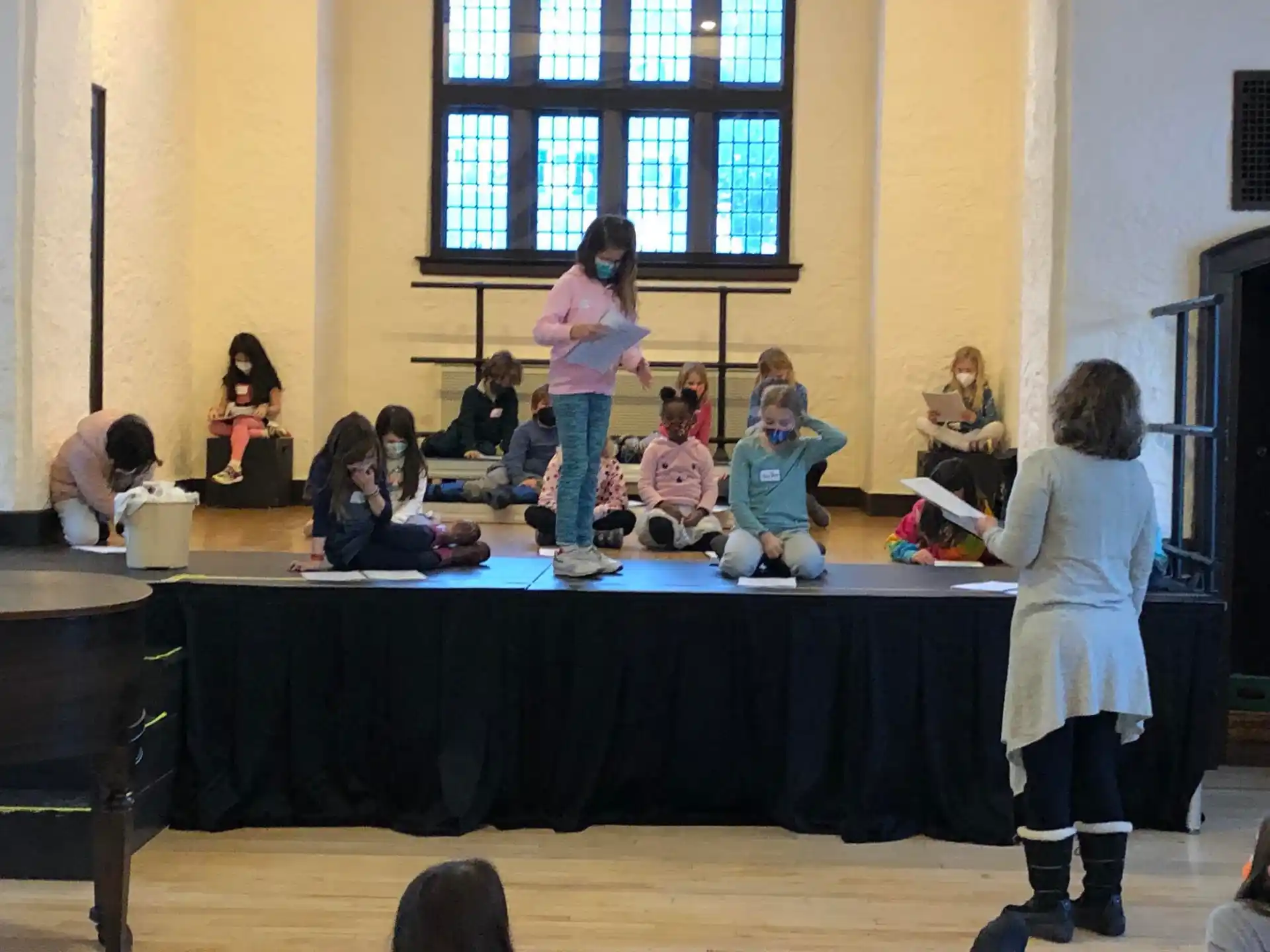 a group of children performing on a stage