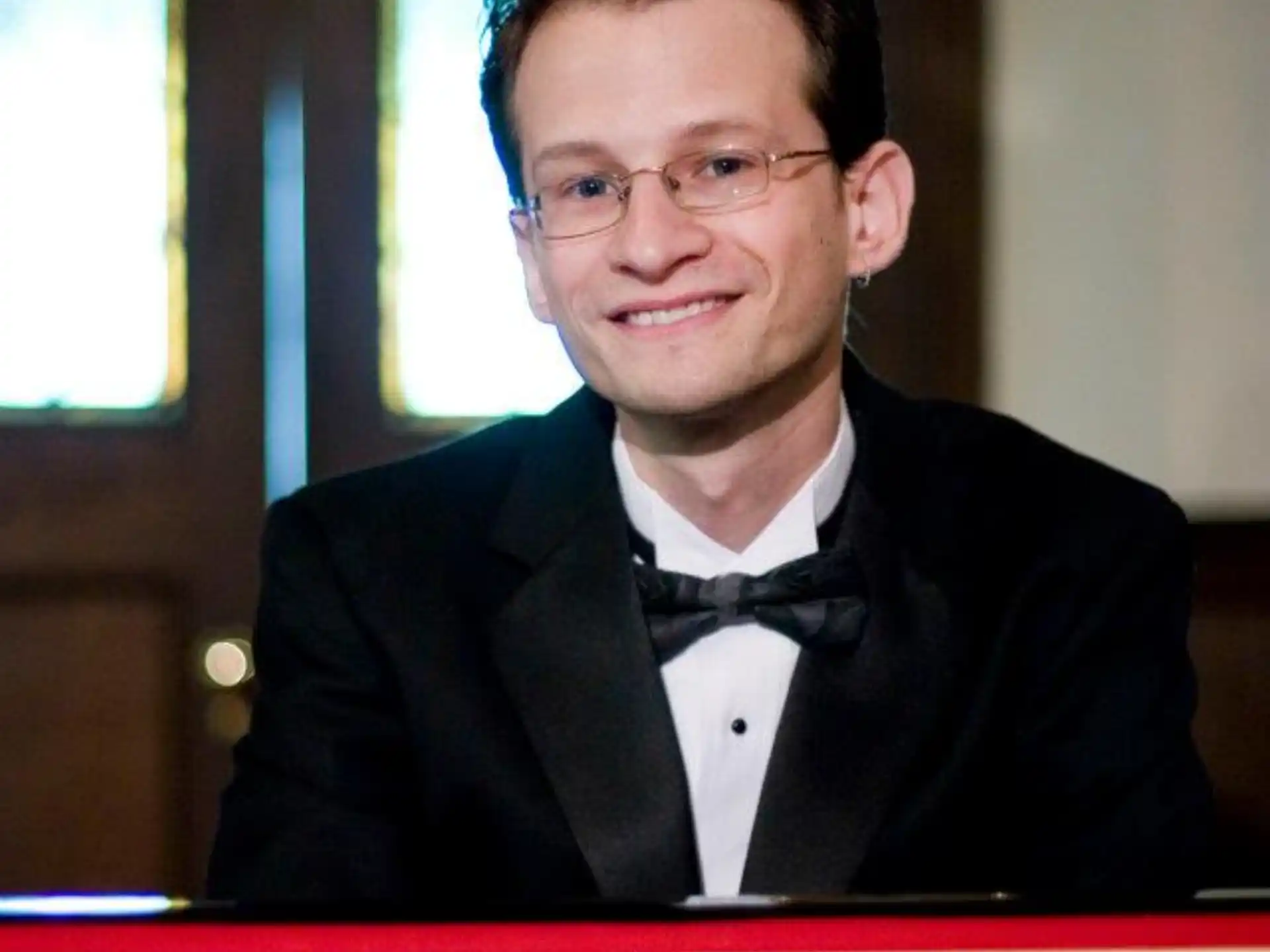 a man in a suit and bow tie