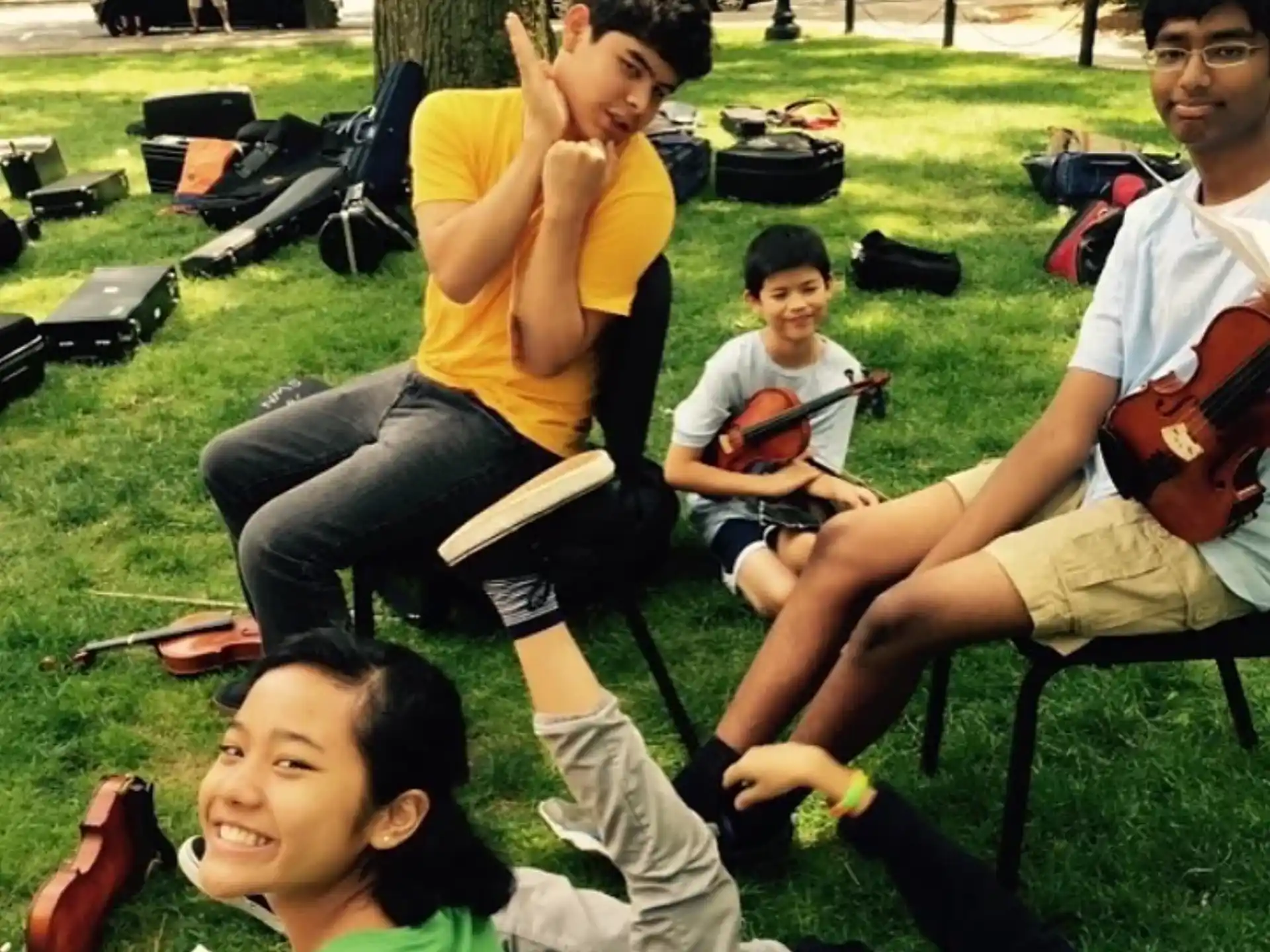 a group of people sitting on the grass
