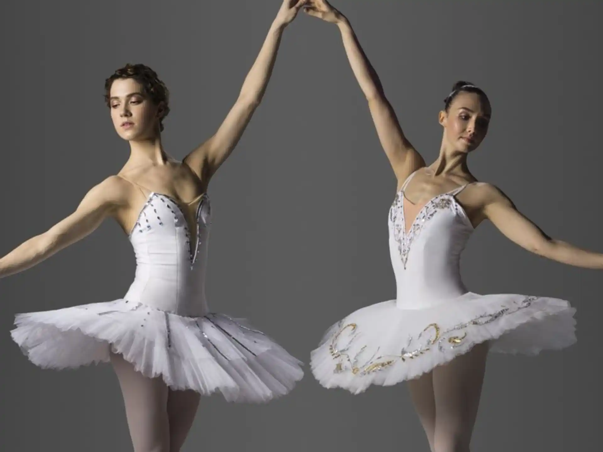 two women dancing in white dresses
