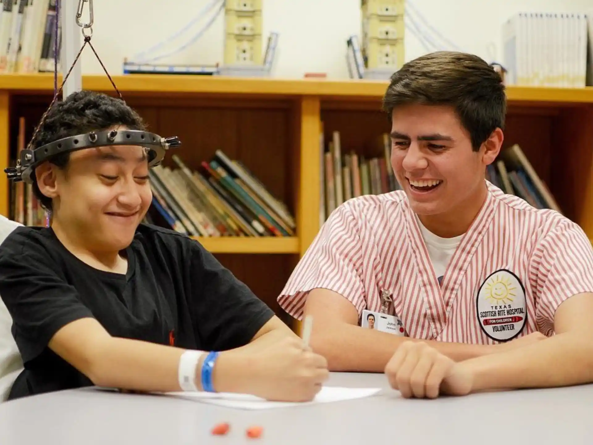 a person and a boy sitting at a table