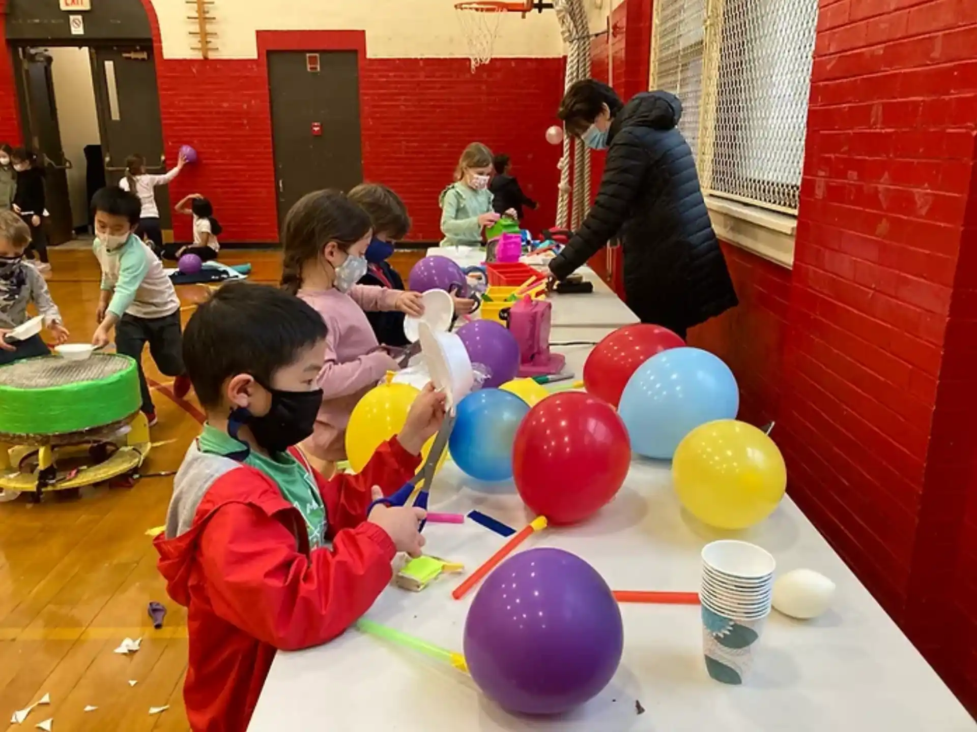 a group of children playing with balloons