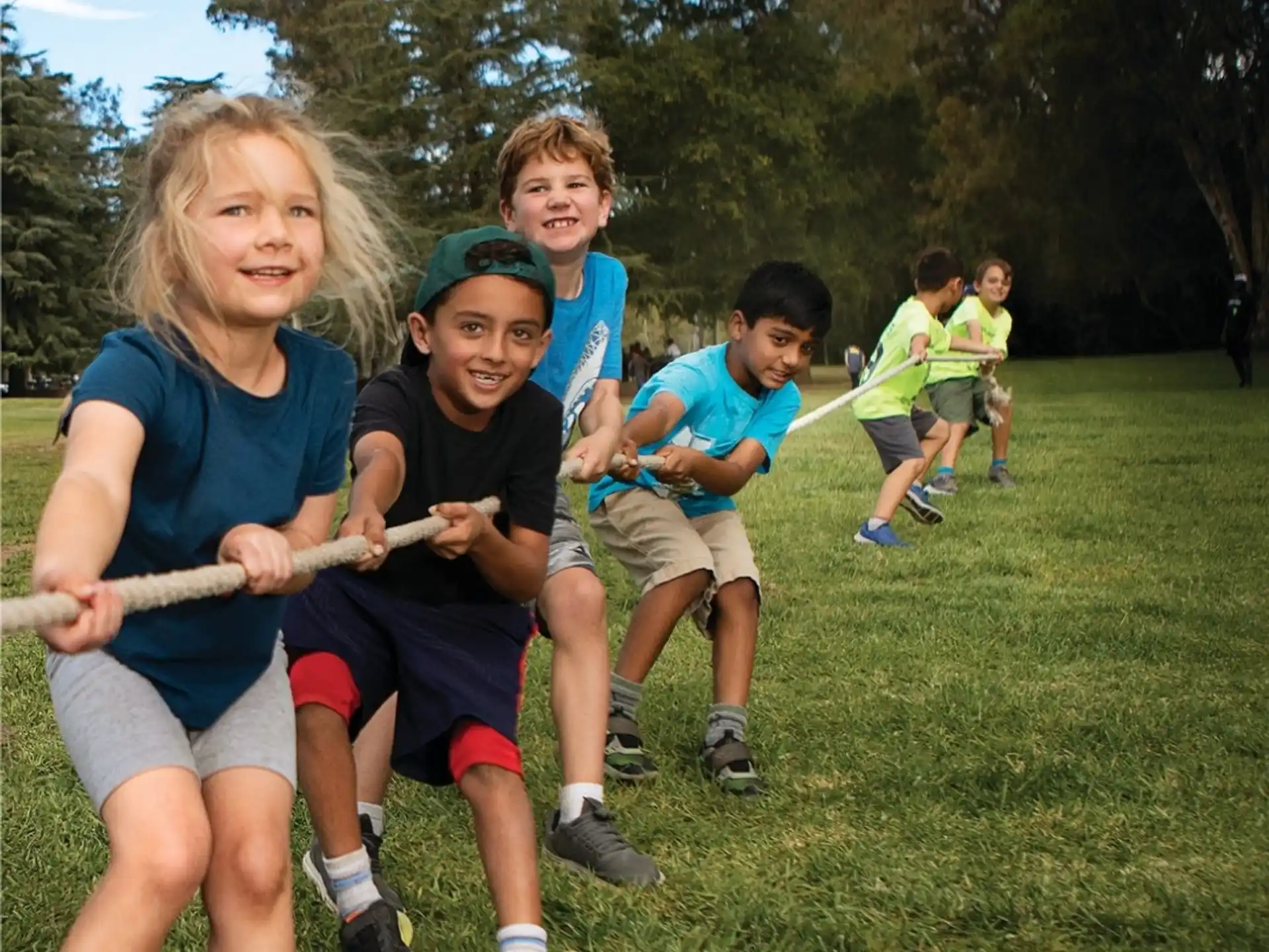 a group of kids playing with a stick