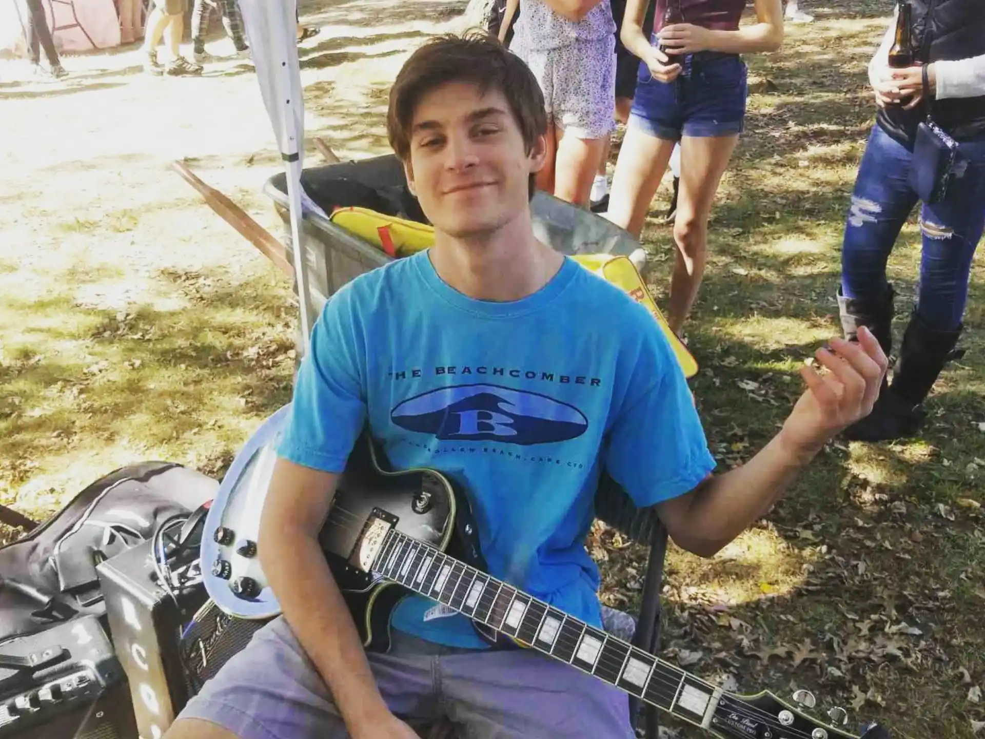 a man sitting on a chair holding a guitar