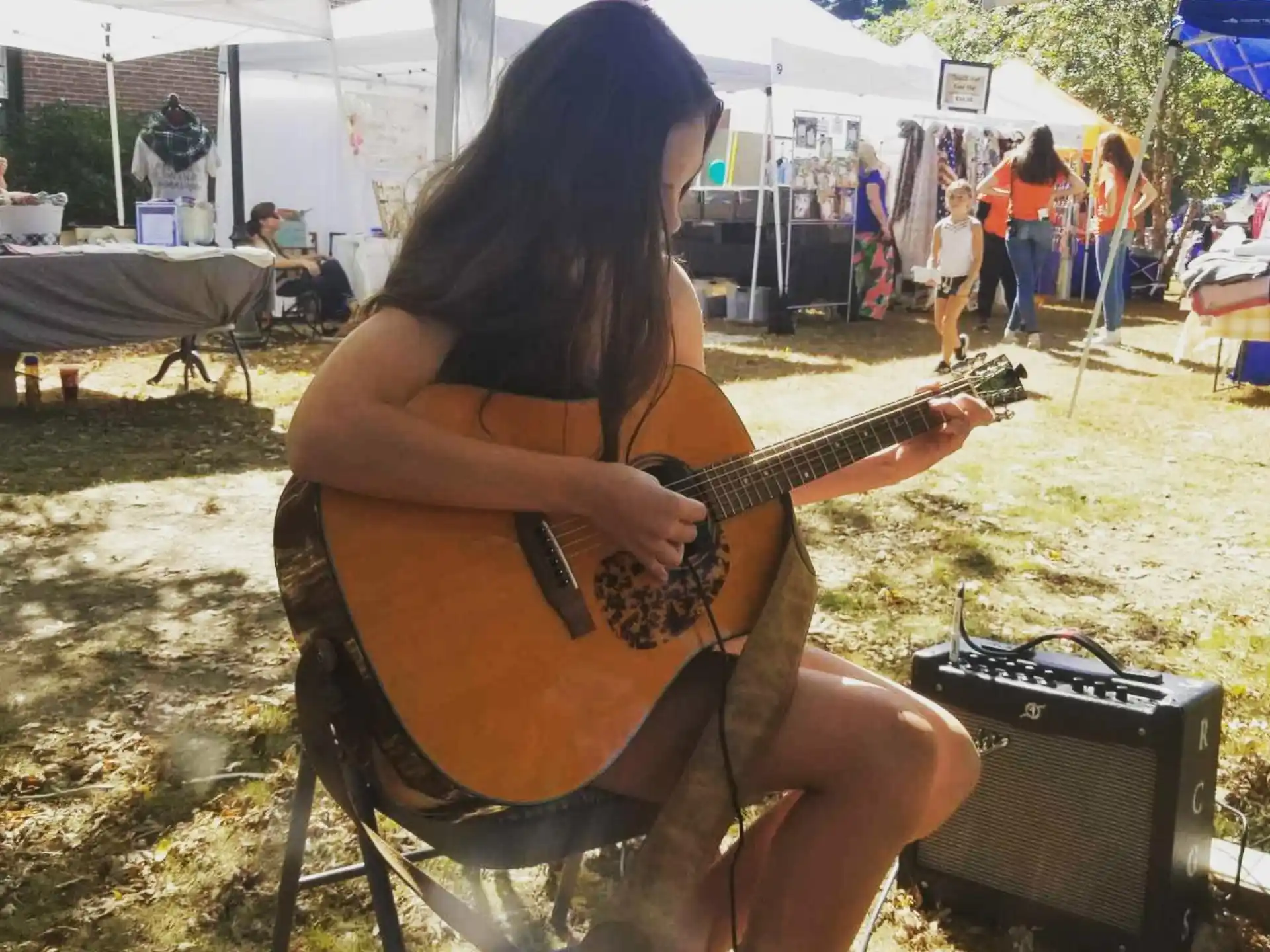 a woman playing a guitar