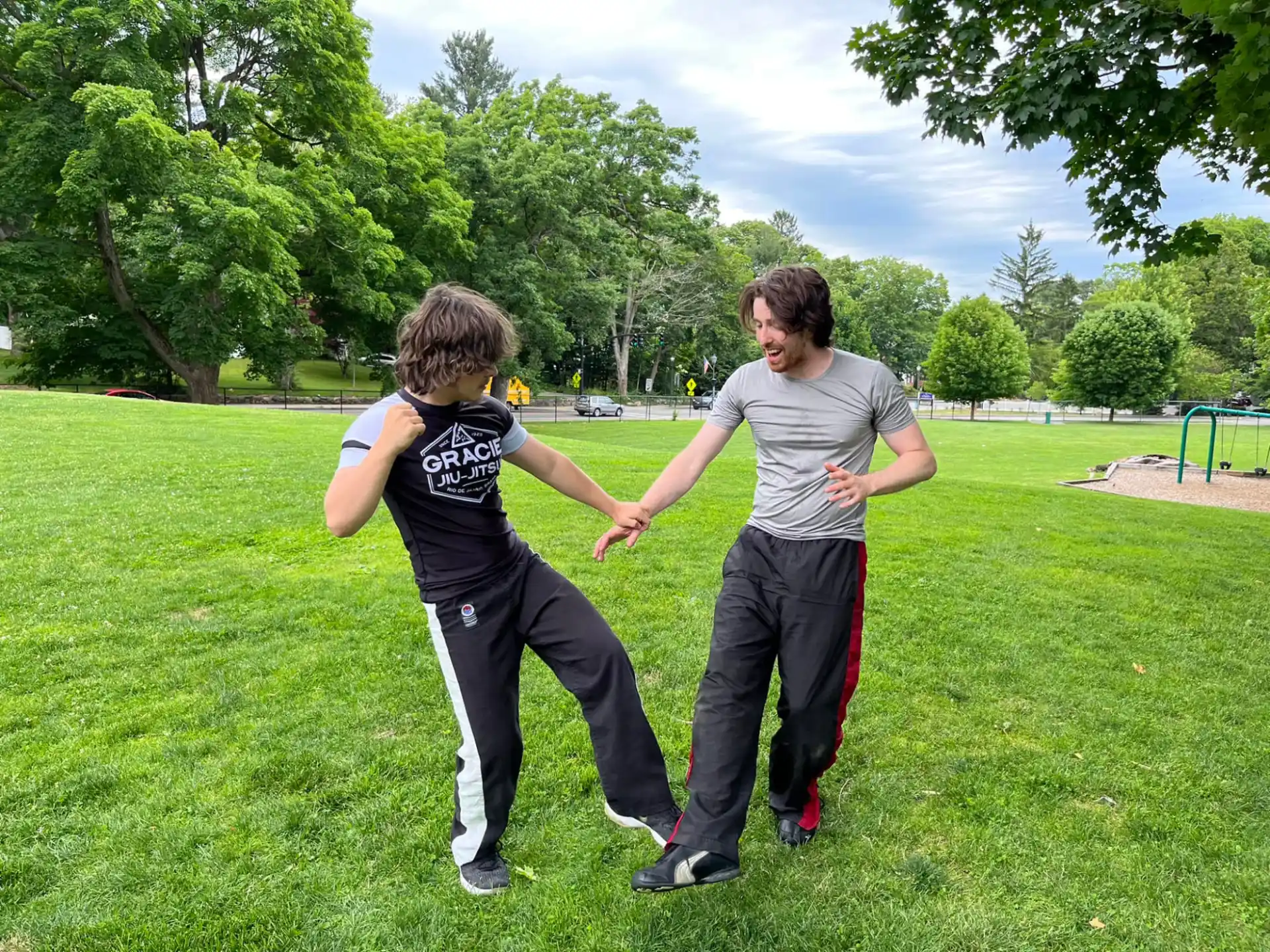 a person and a boy playing in a grass field