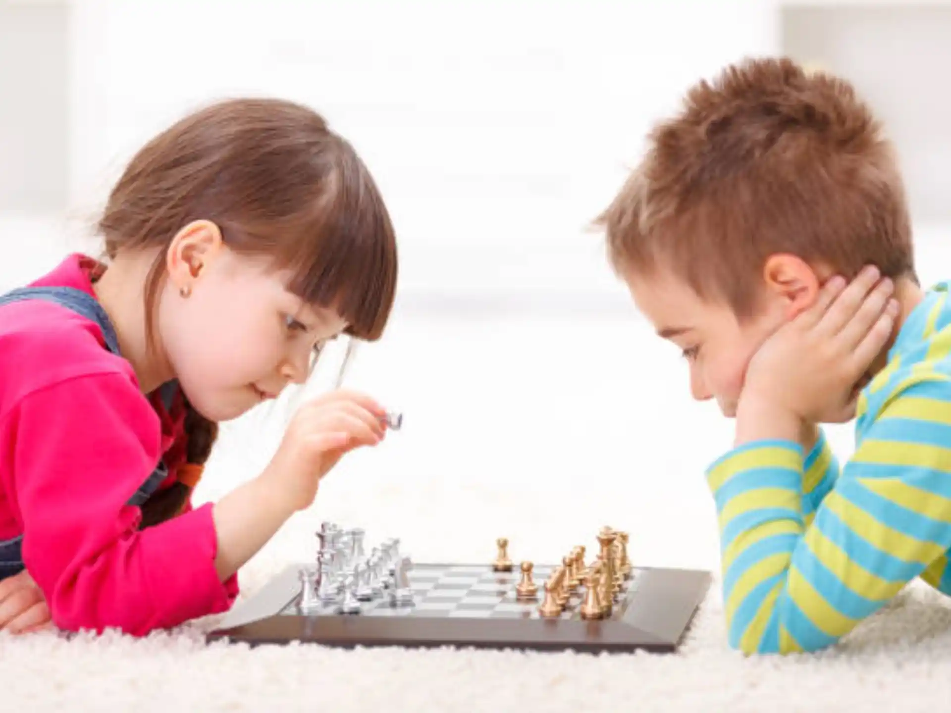 a couple of children playing chess