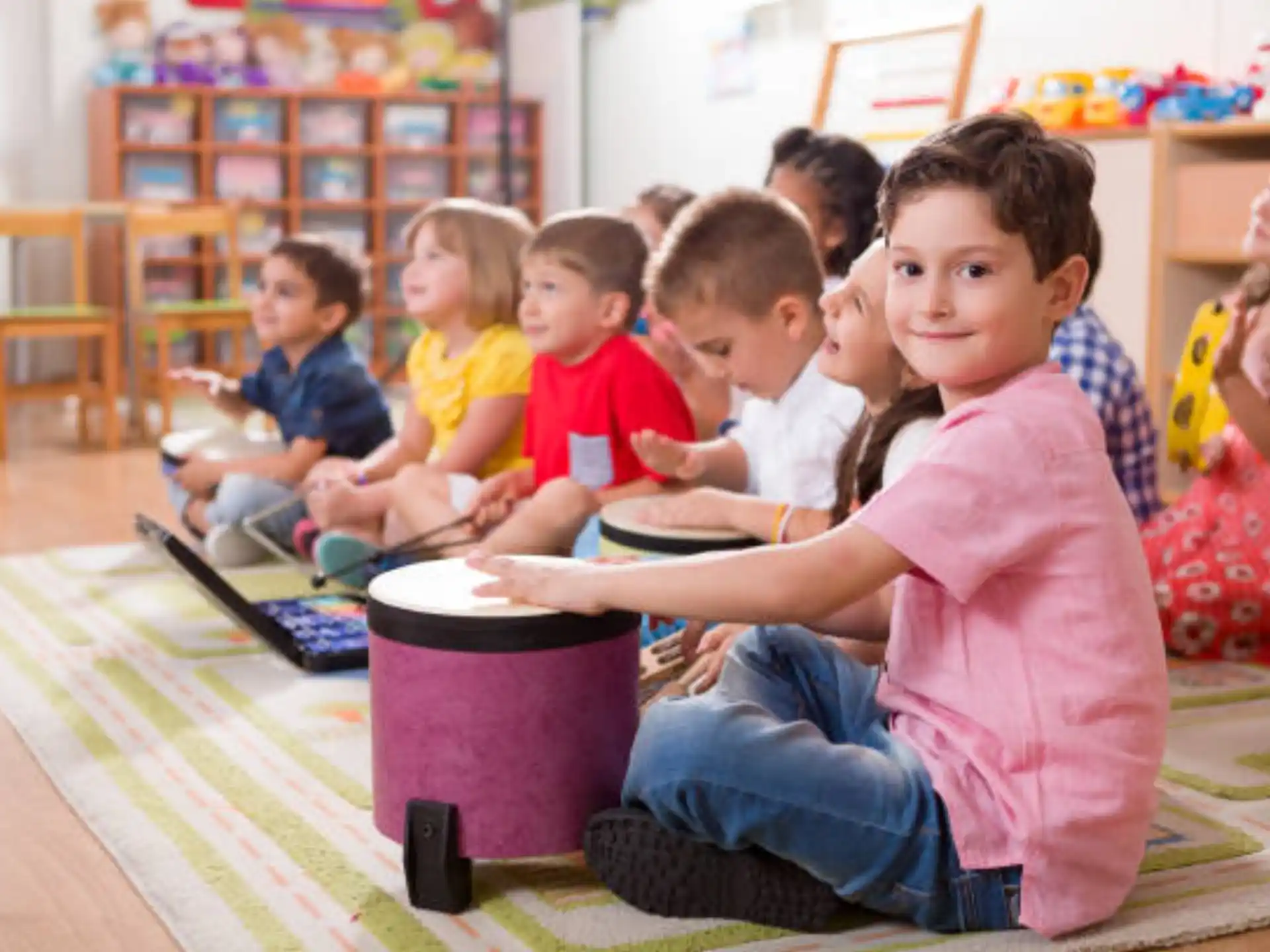 a group of children sitting on the floor playing a game