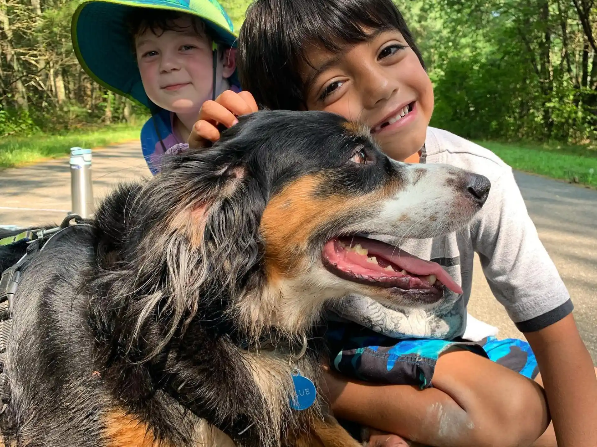 a boy and a girl posing with a dog