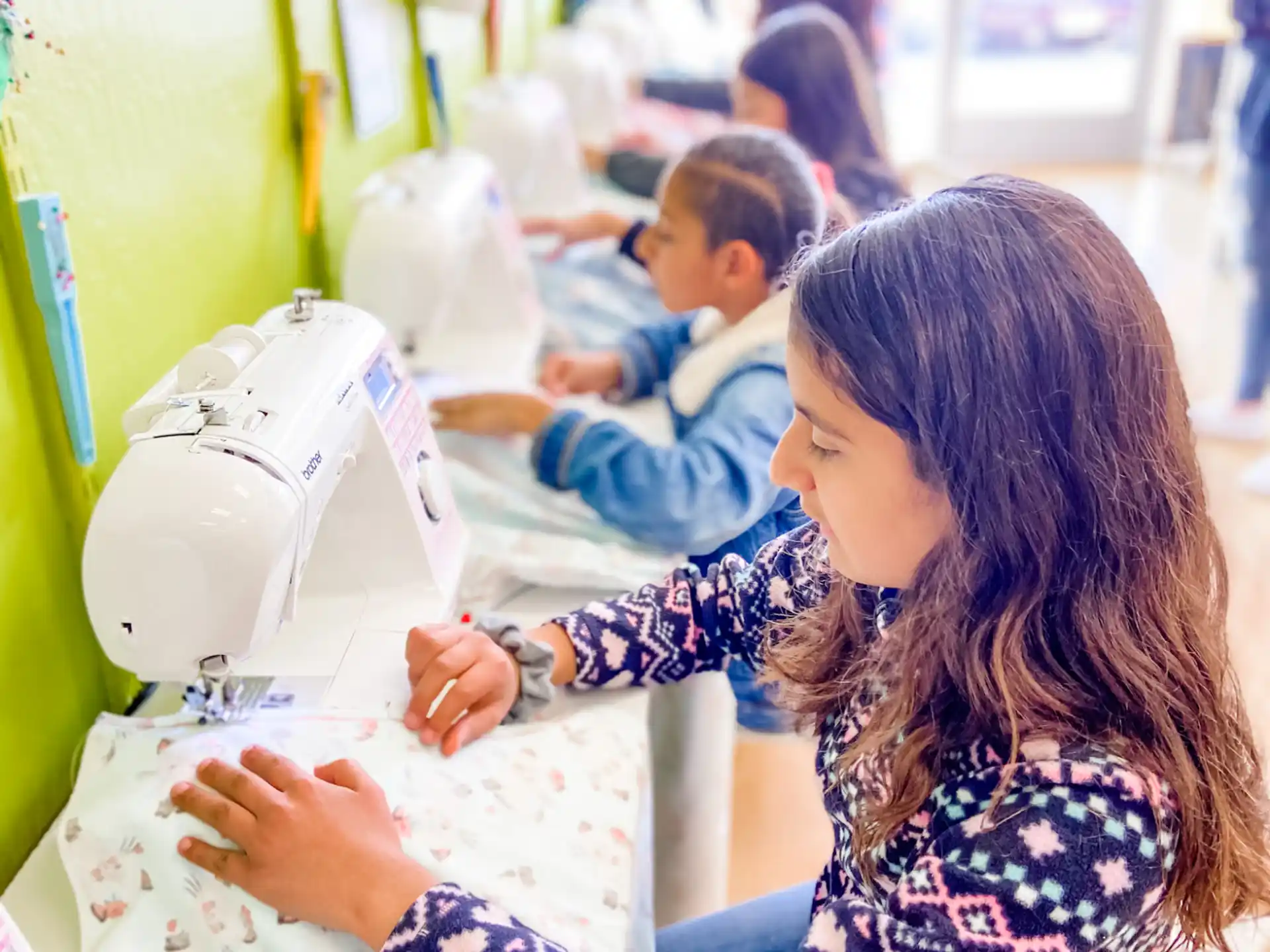 a person sewing a sewing machine