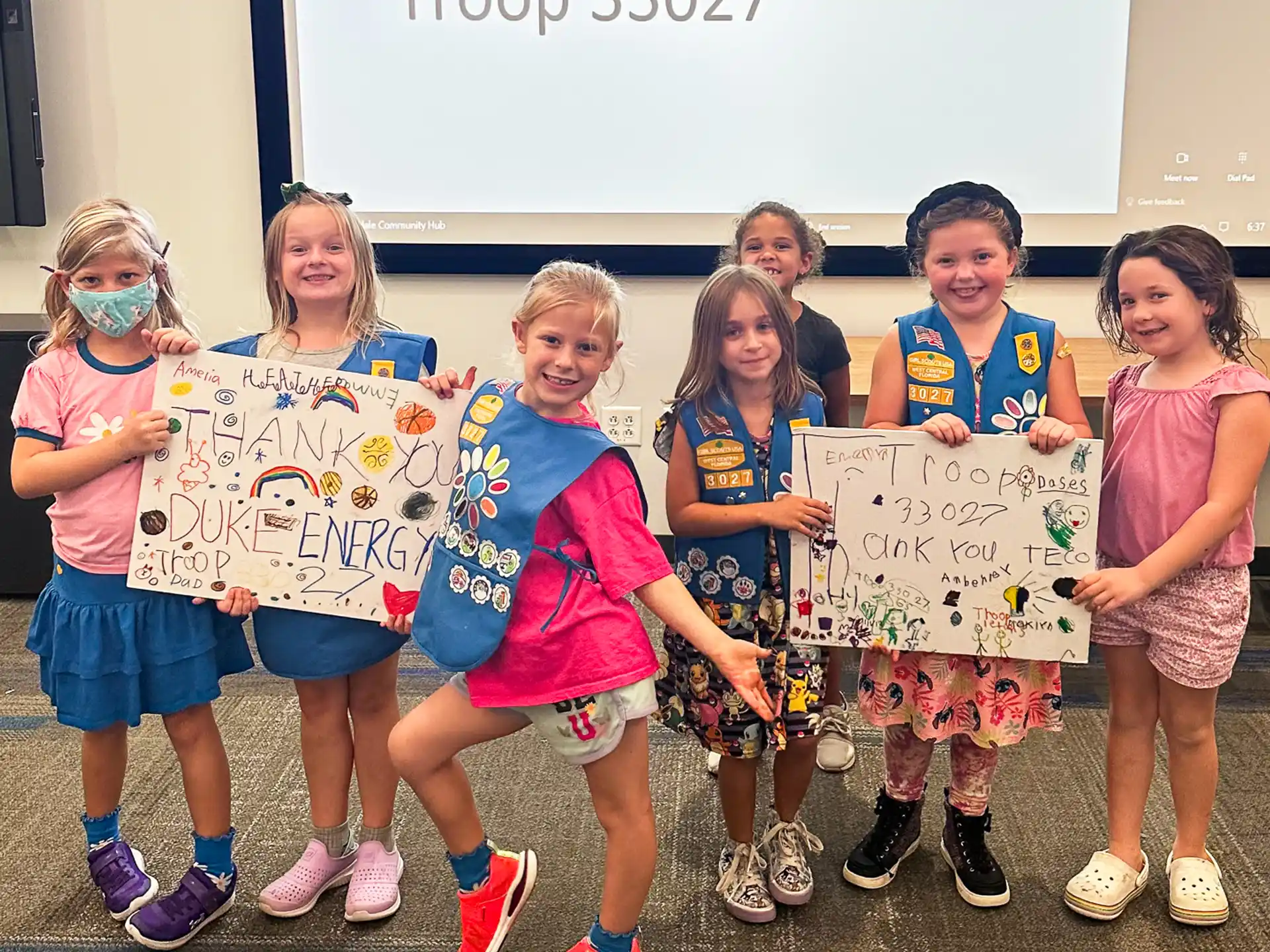 a group of children holding signs