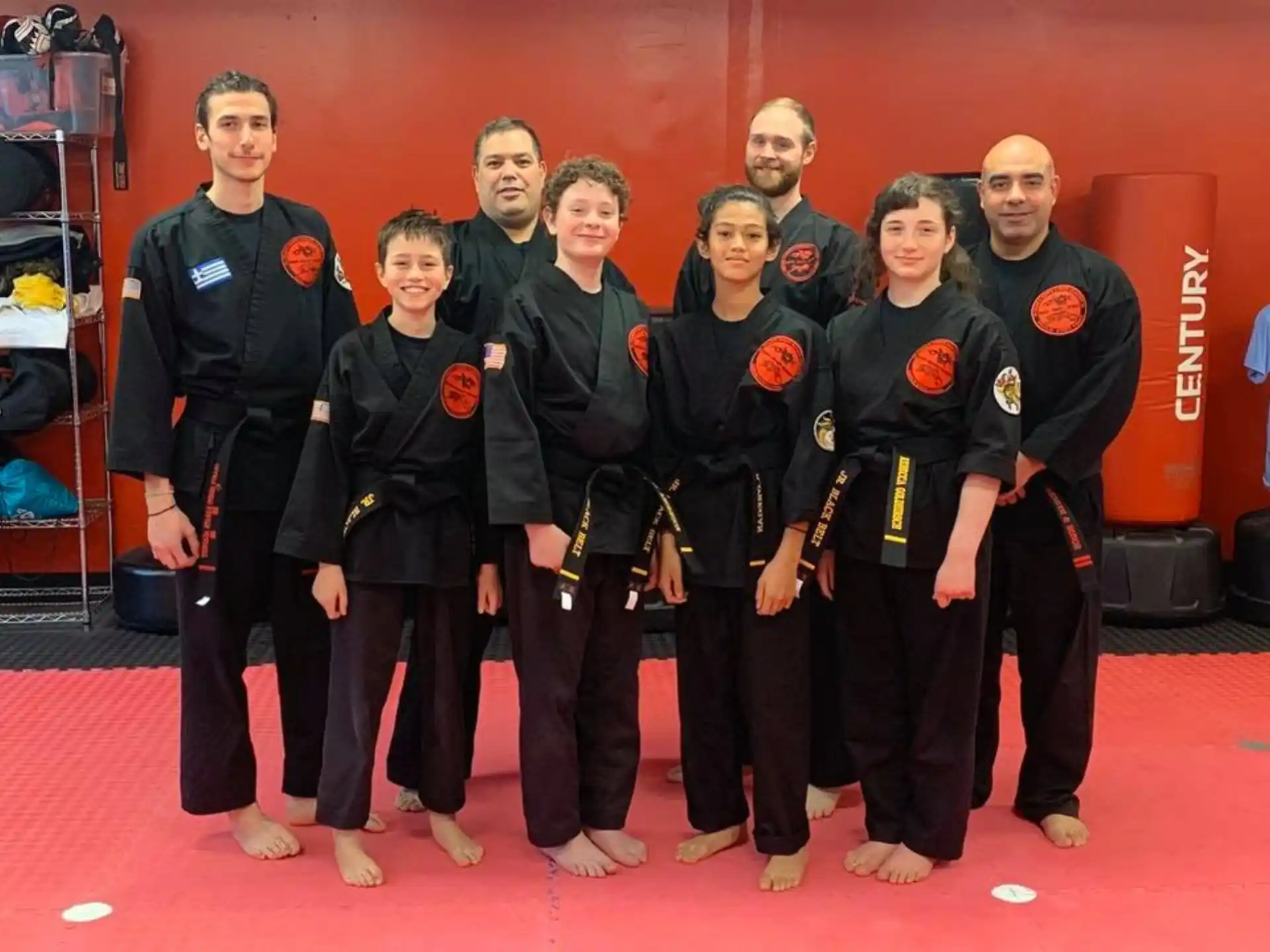 a group of people in black and yellow uniforms standing on a red carpet