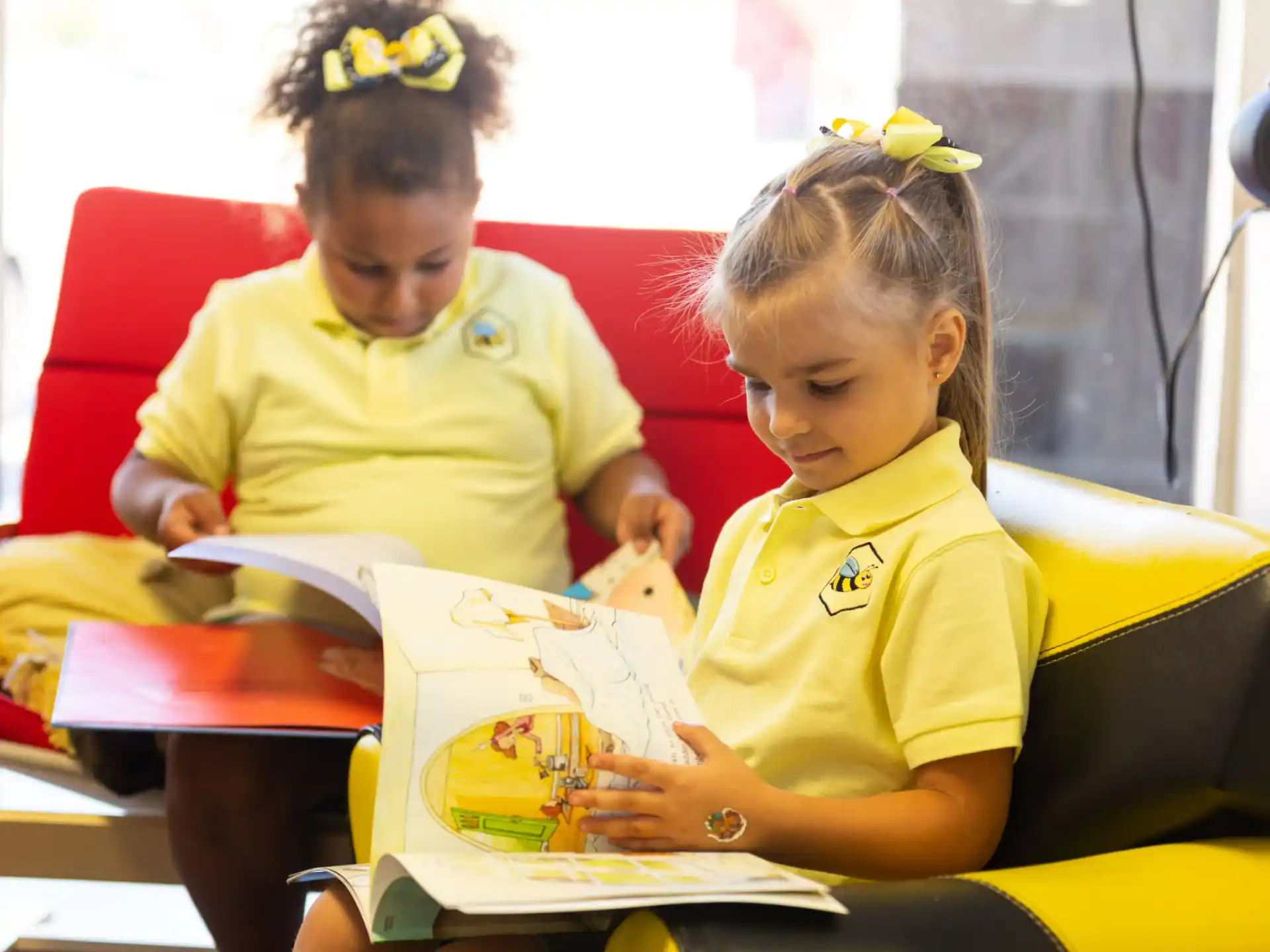a couple of young girls reading books