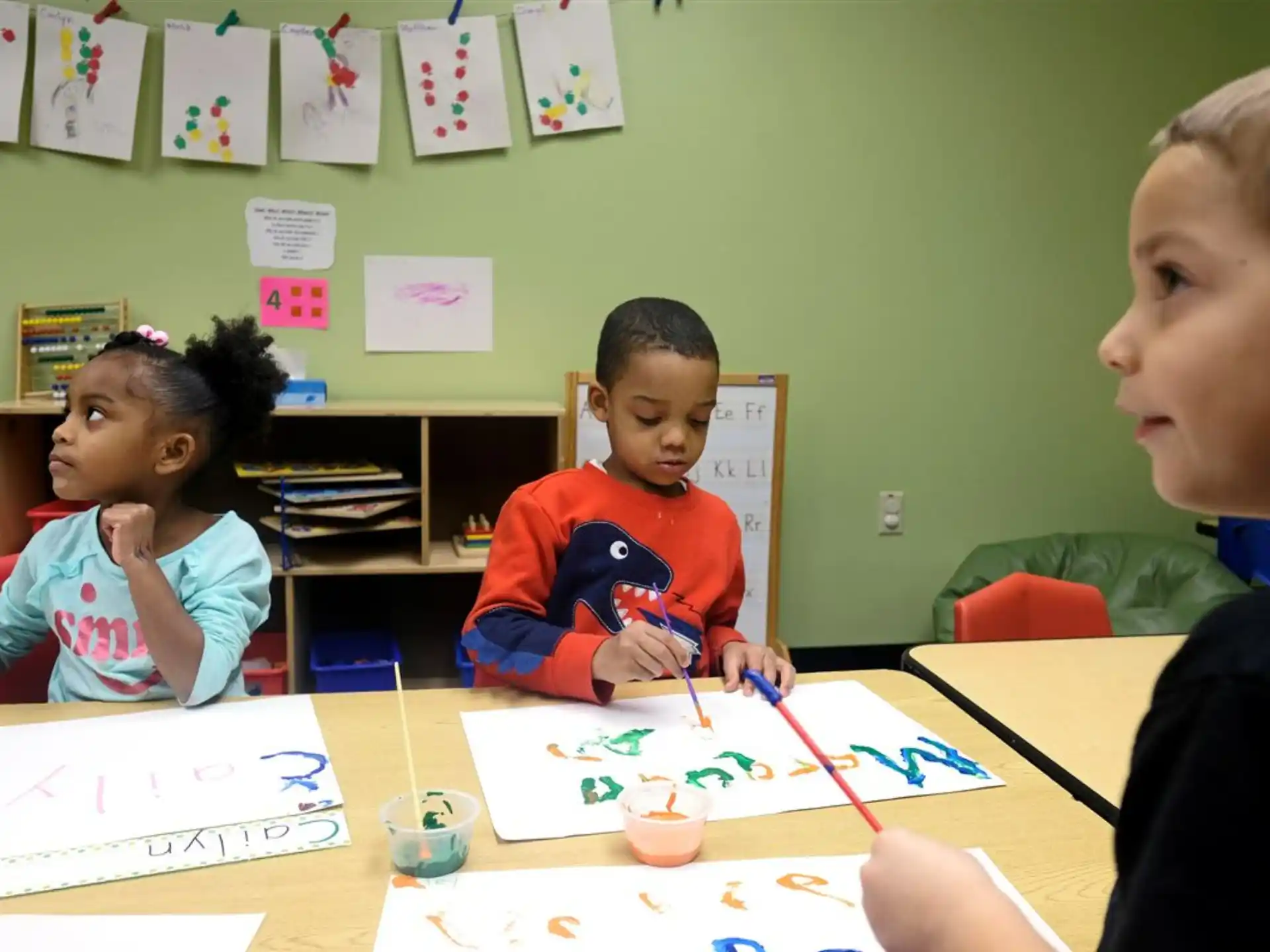 a group of children sitting at a table