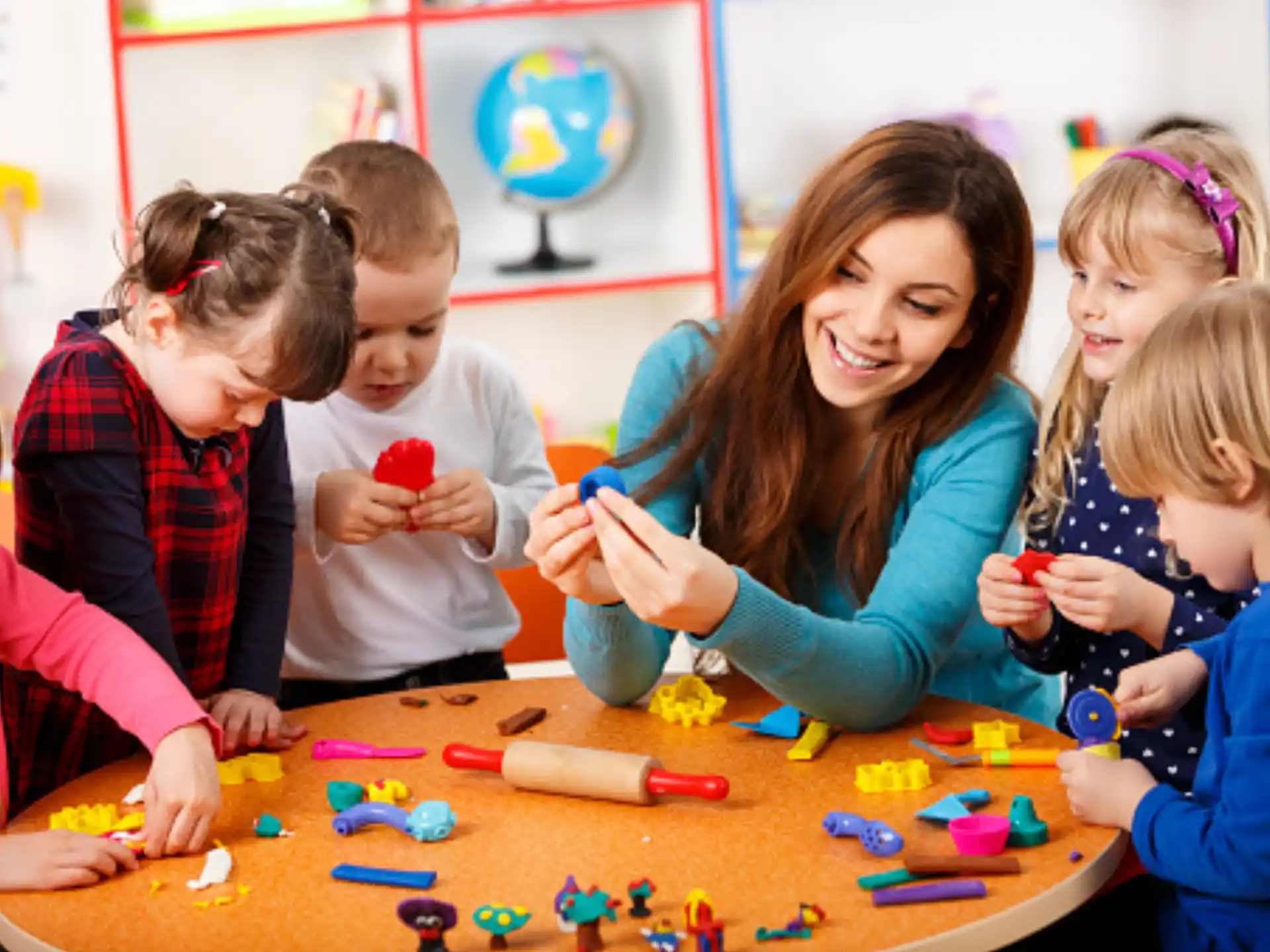 a person and several children playing with toys