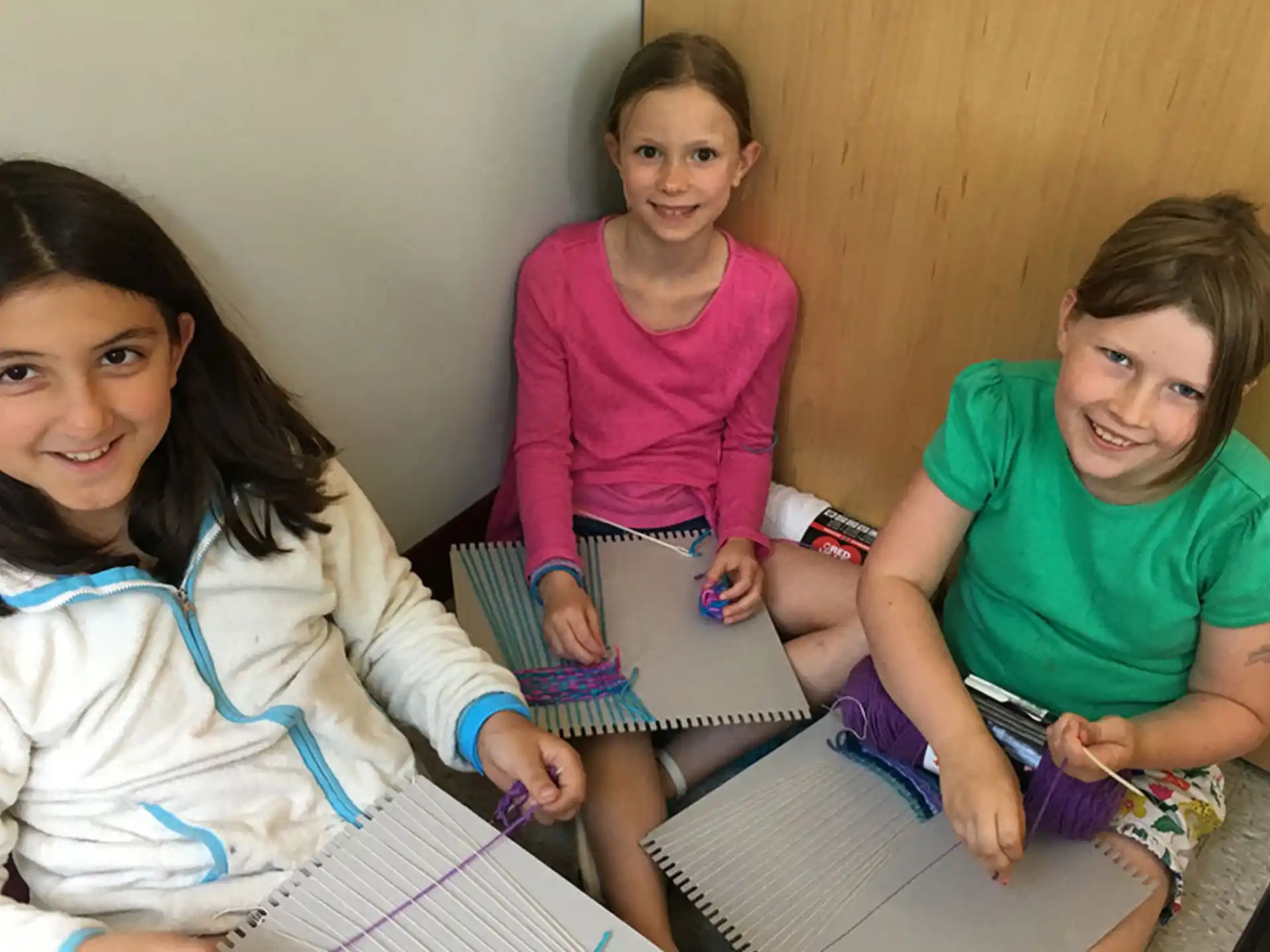 a group of girls sitting on the floor