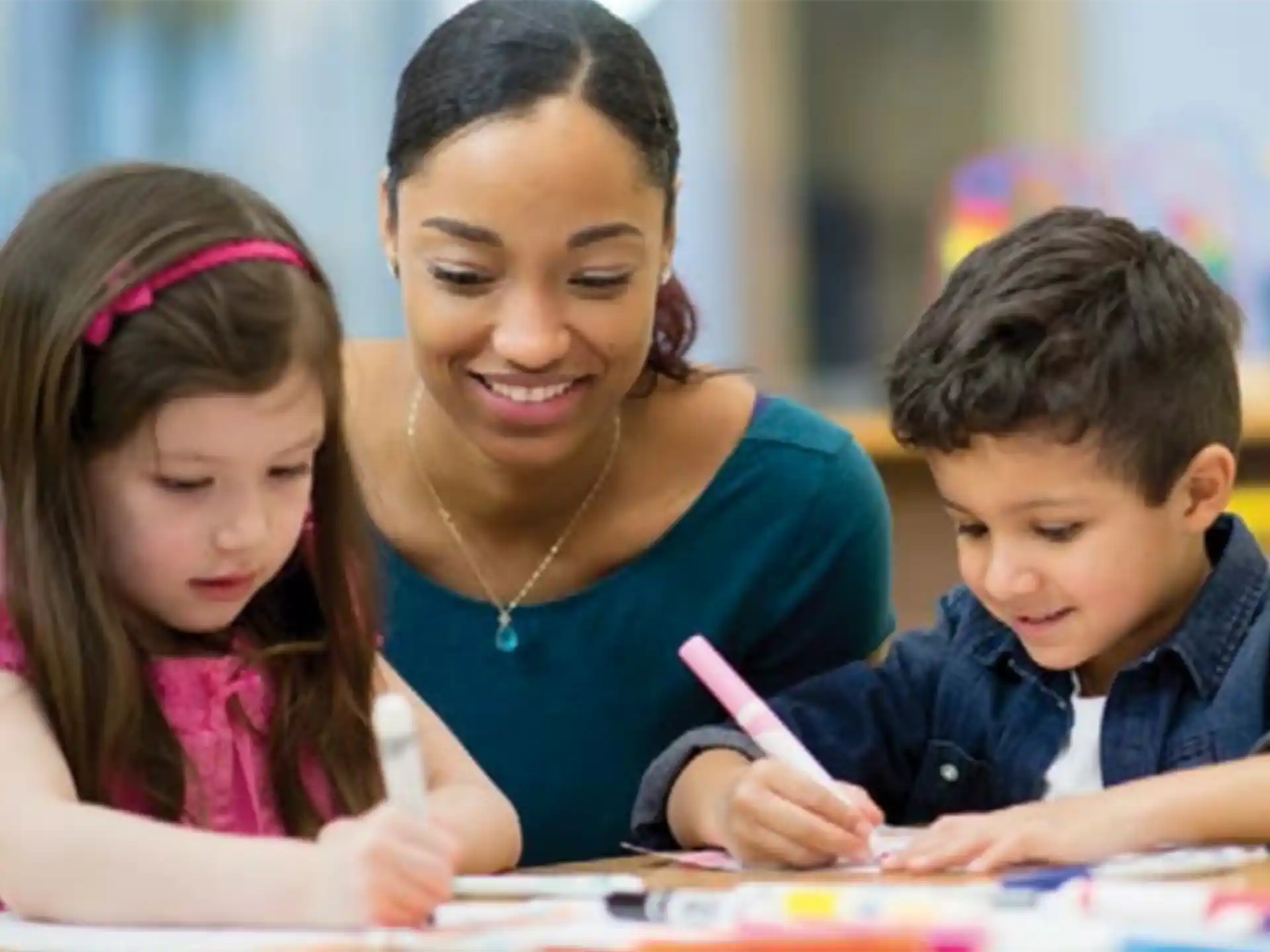 a person and children looking at a paper