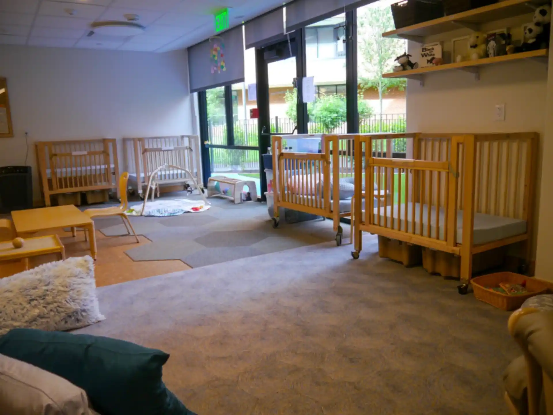 a room with a large window and a wood bench