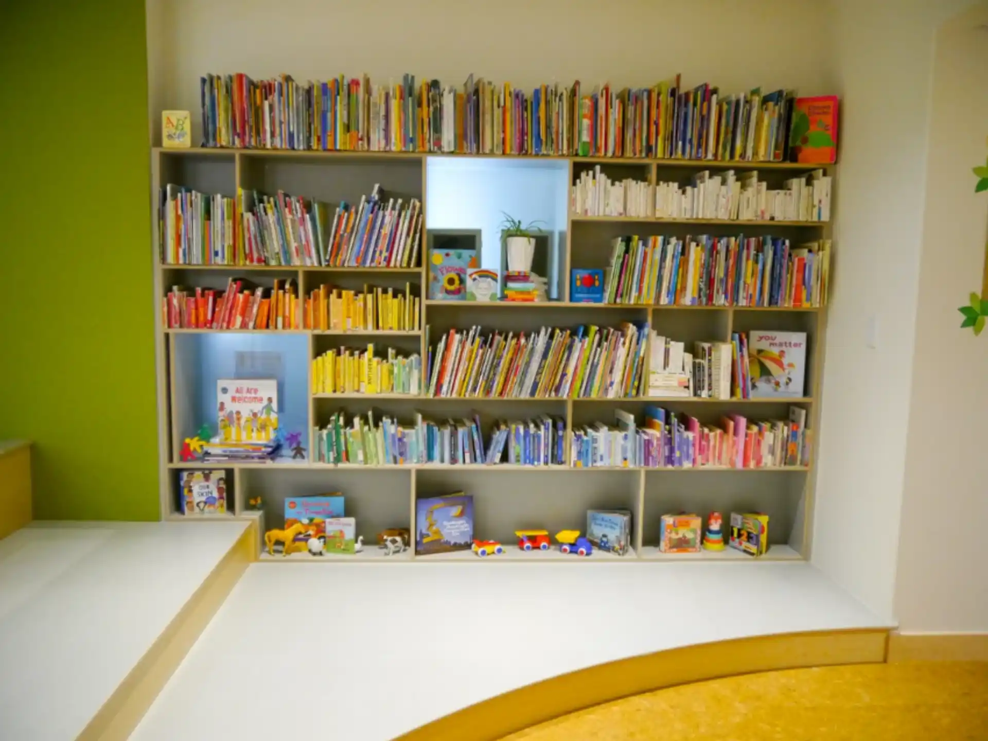 a shelf with books and toys