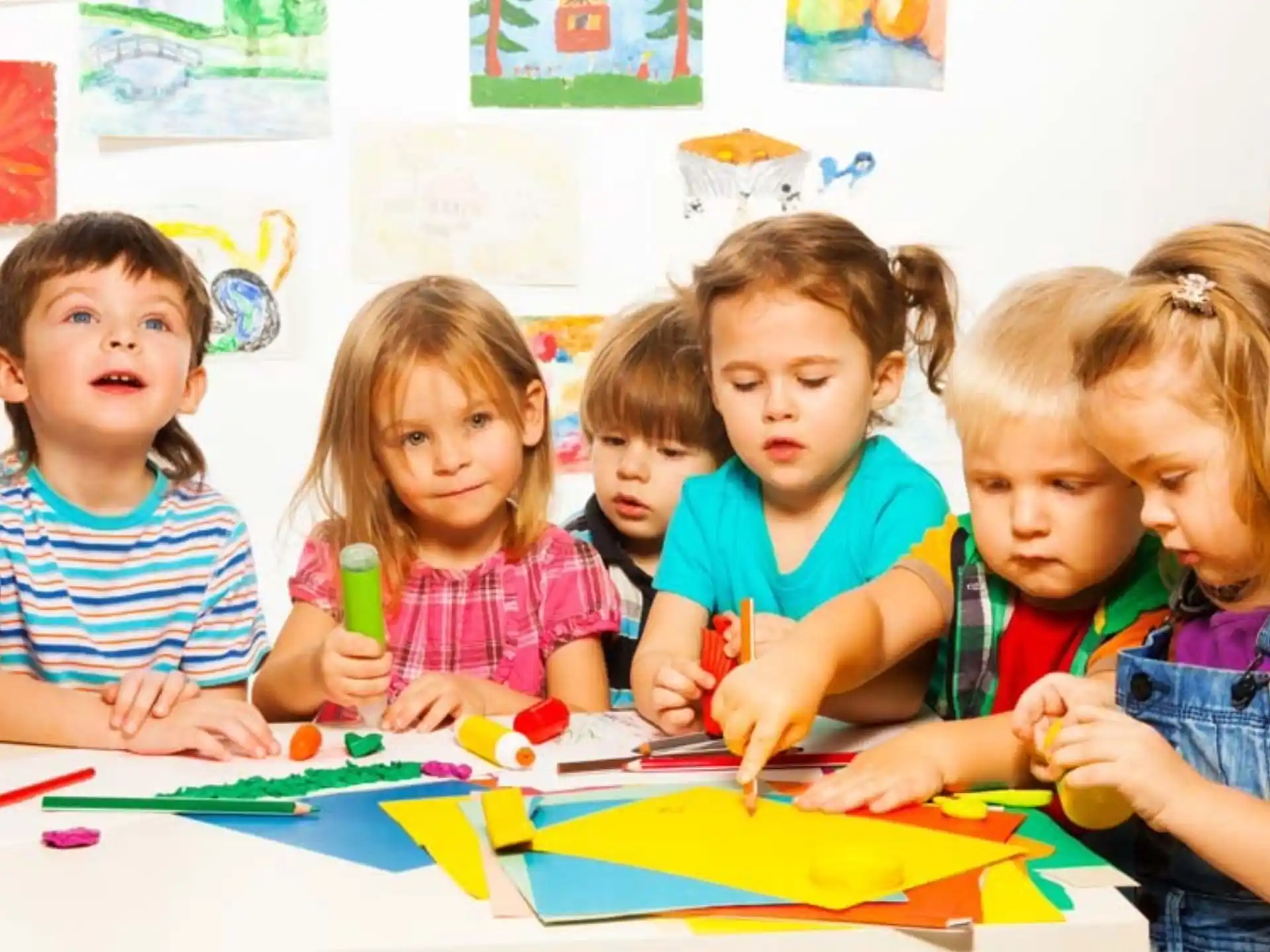 a group of children sitting at a table