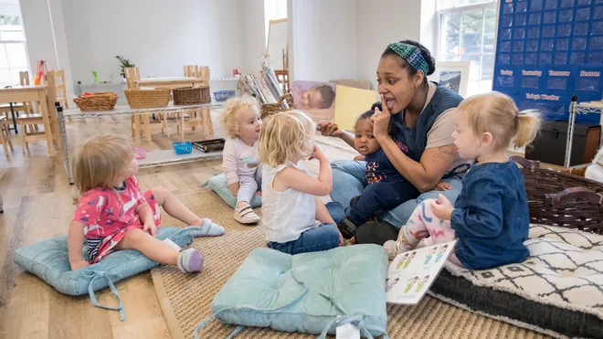 a person and several children sitting on the floor