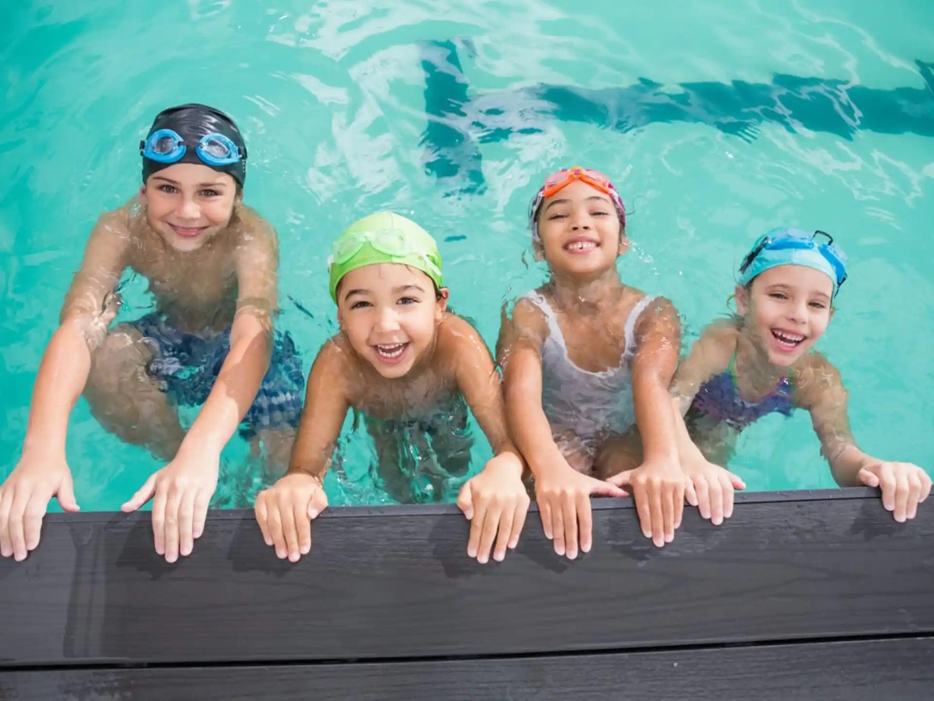 a group of girls in swimsuits in a pool