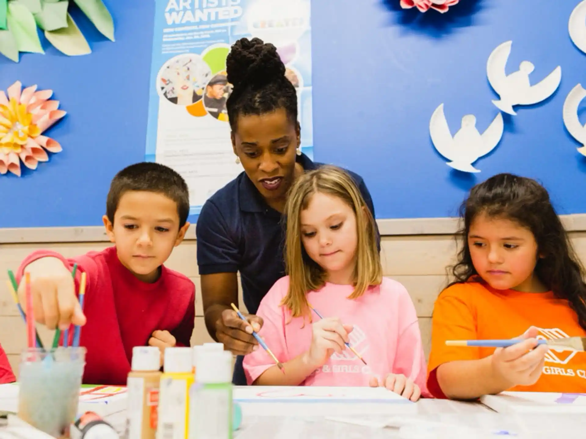 a group of children sitting at a table