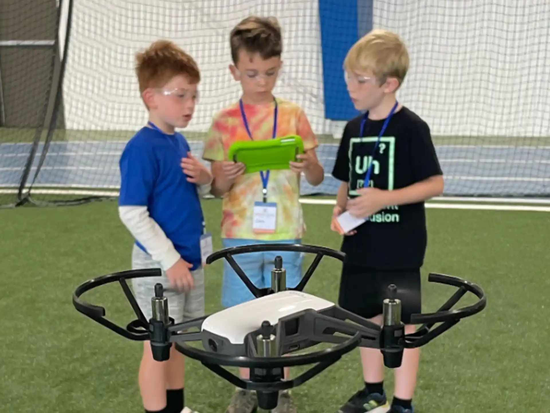 a group of boys standing around a table with a trophy
