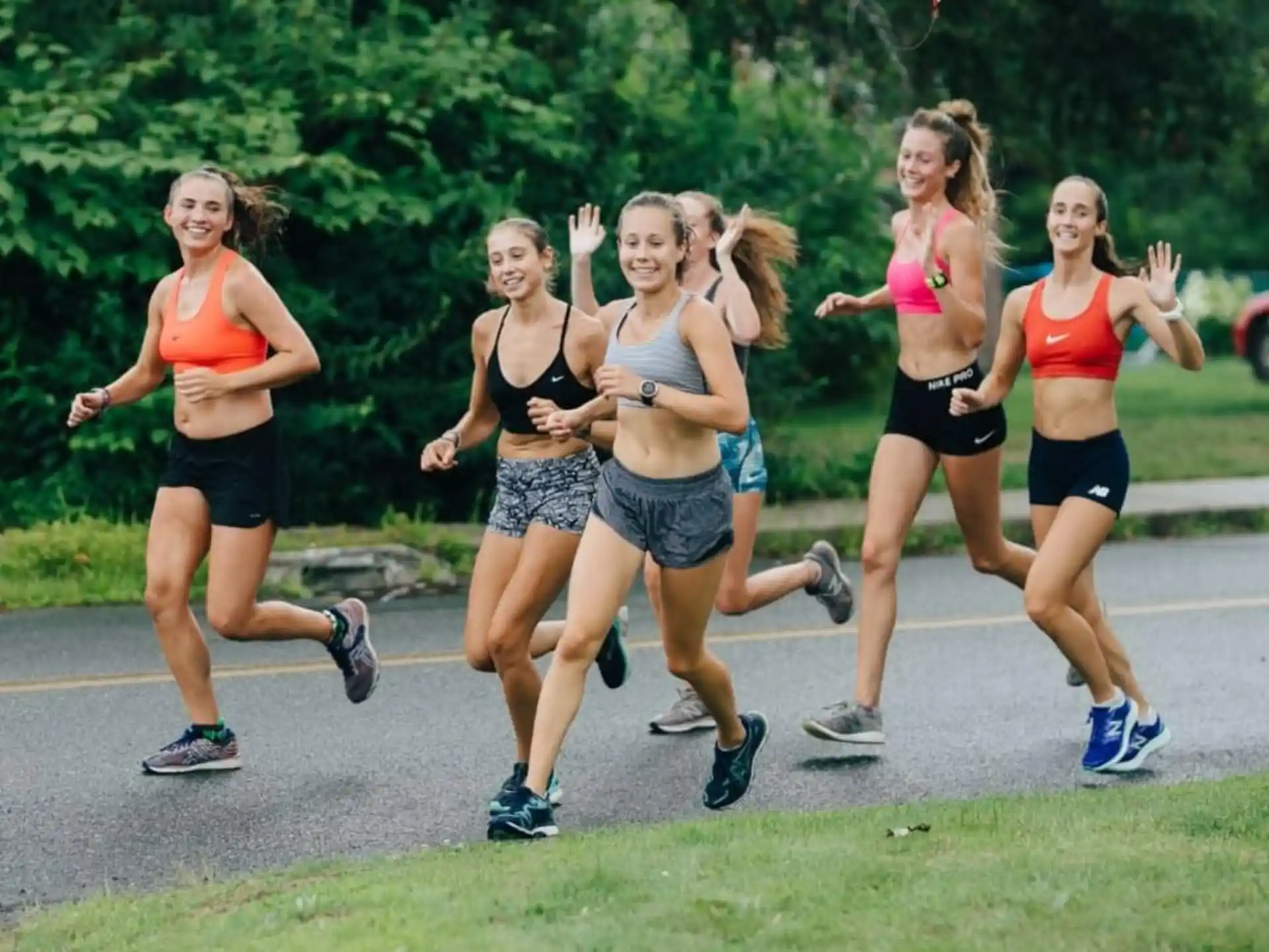 a group of women running on a road
