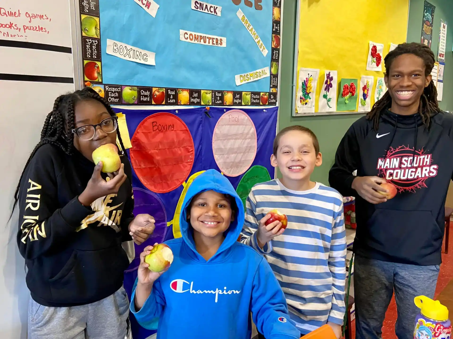 a group of people holding fruit