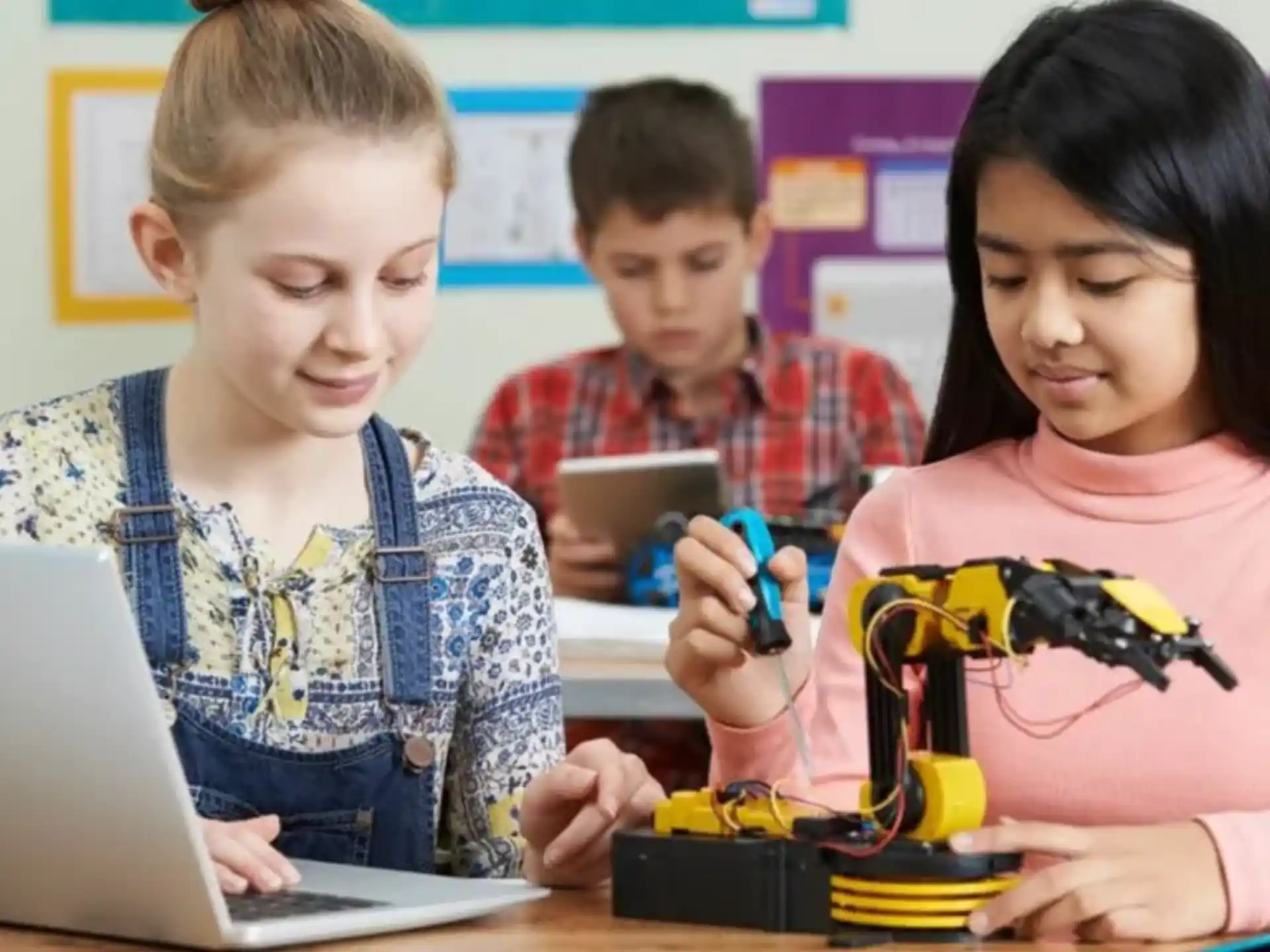 a few children working on a laptop