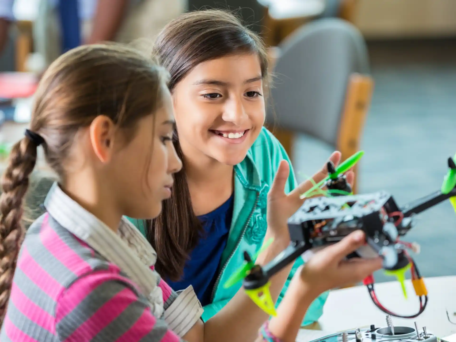 a few young girls working on a project