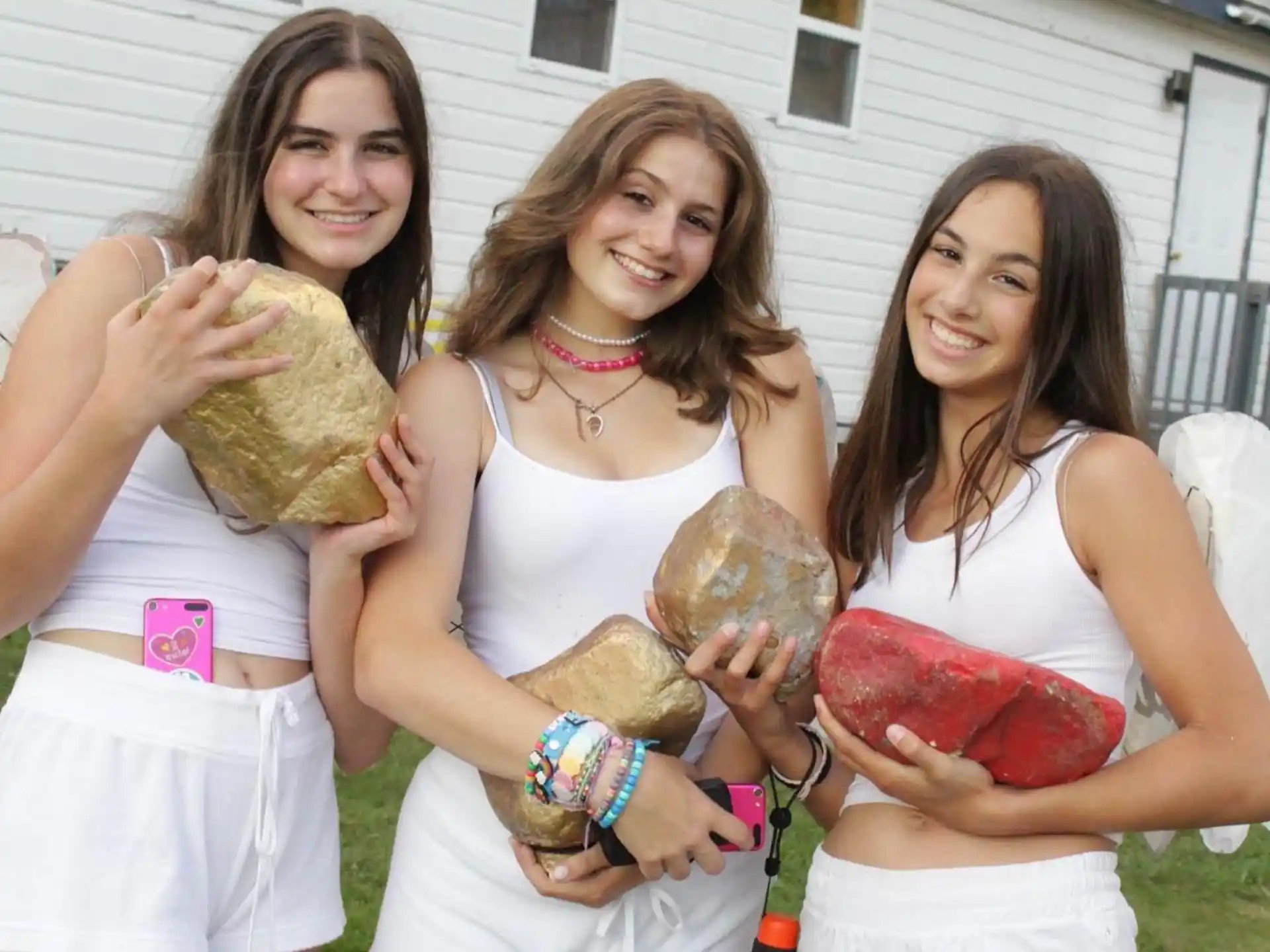 a group of girls holding a baby