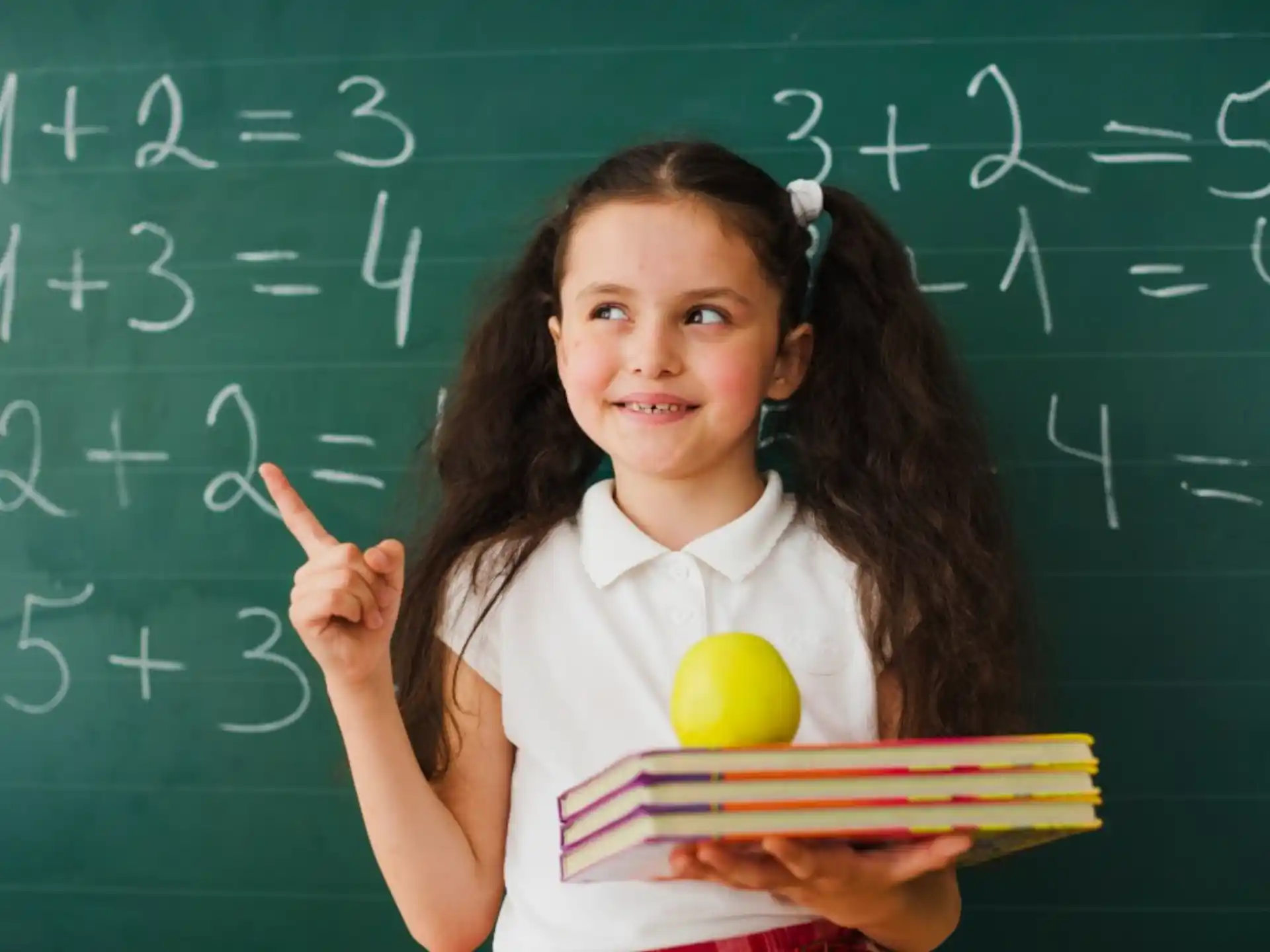a girl holding a ball and a ball in front of her