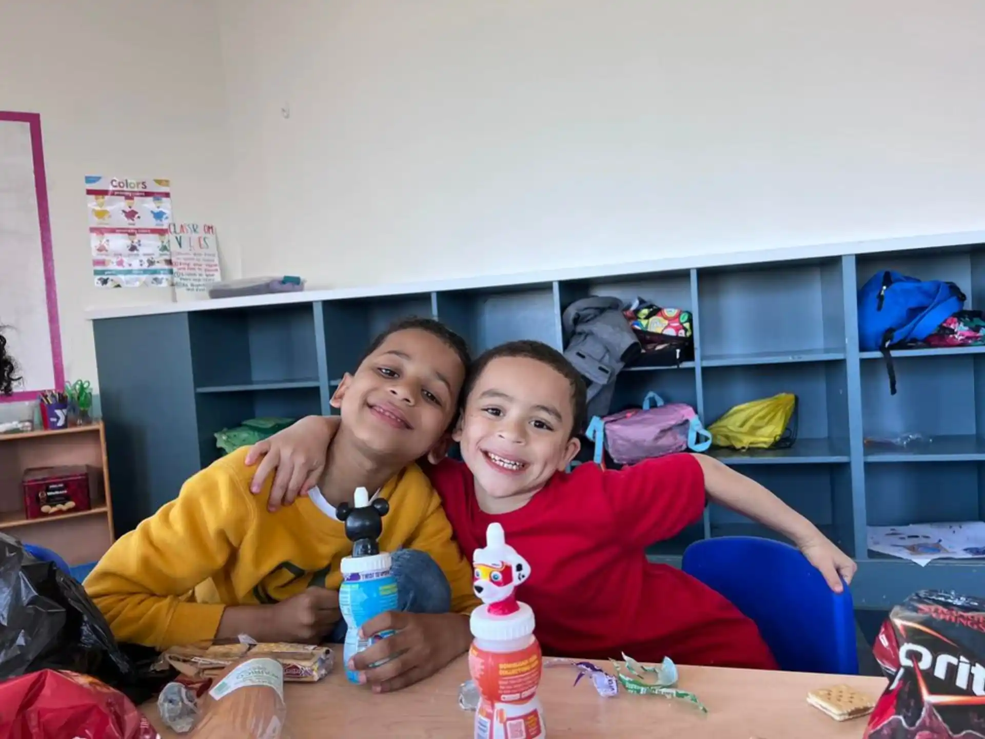 two boys sitting at a table