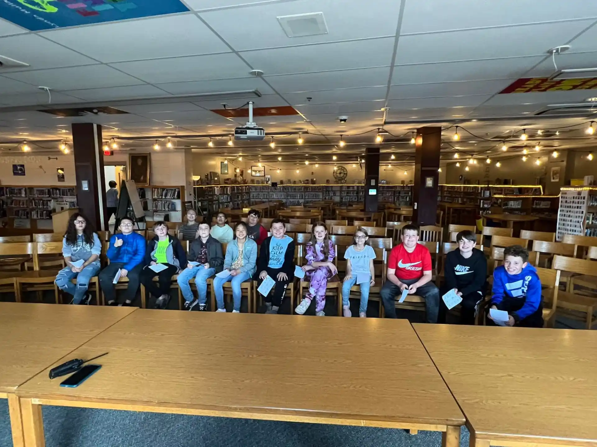 a group of people posing for a photo in a lecture hall