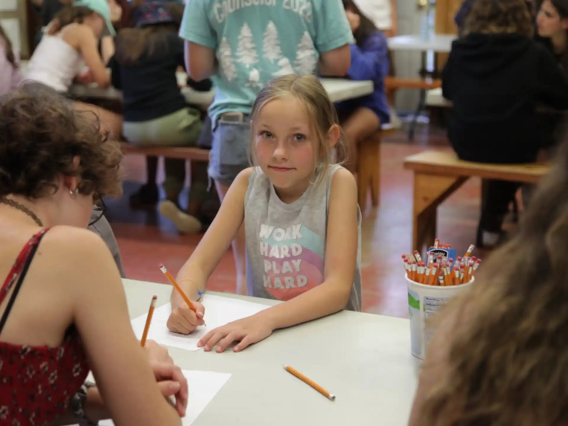 a girl sitting at a table